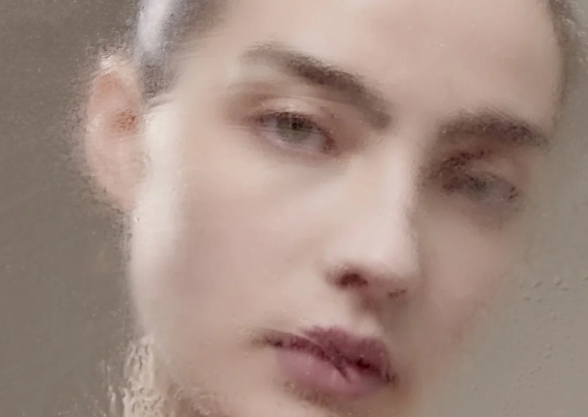 Beauty close-up of a male model's face with an artistic blurred, textured effect, for an experimental men's grooming and skincare campaign by Adrianna Favero, NYC beauty photographer and director.