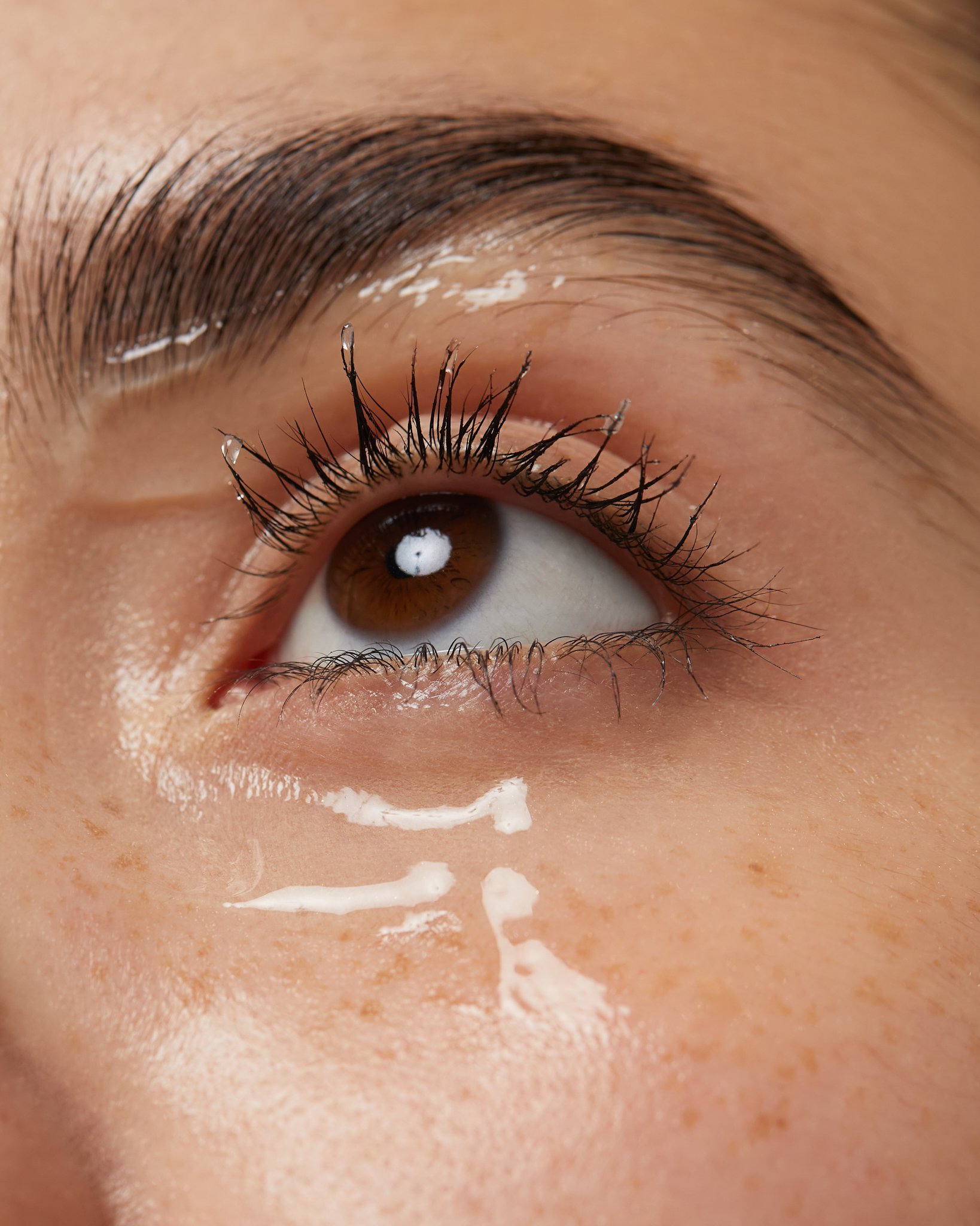 Extreme close-up macro beauty shot of an eye with defined lashes and mascara, by Adrianna Favero.