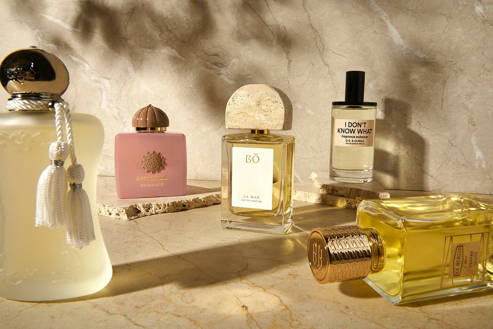 Perfume bottles displayed on stone surface