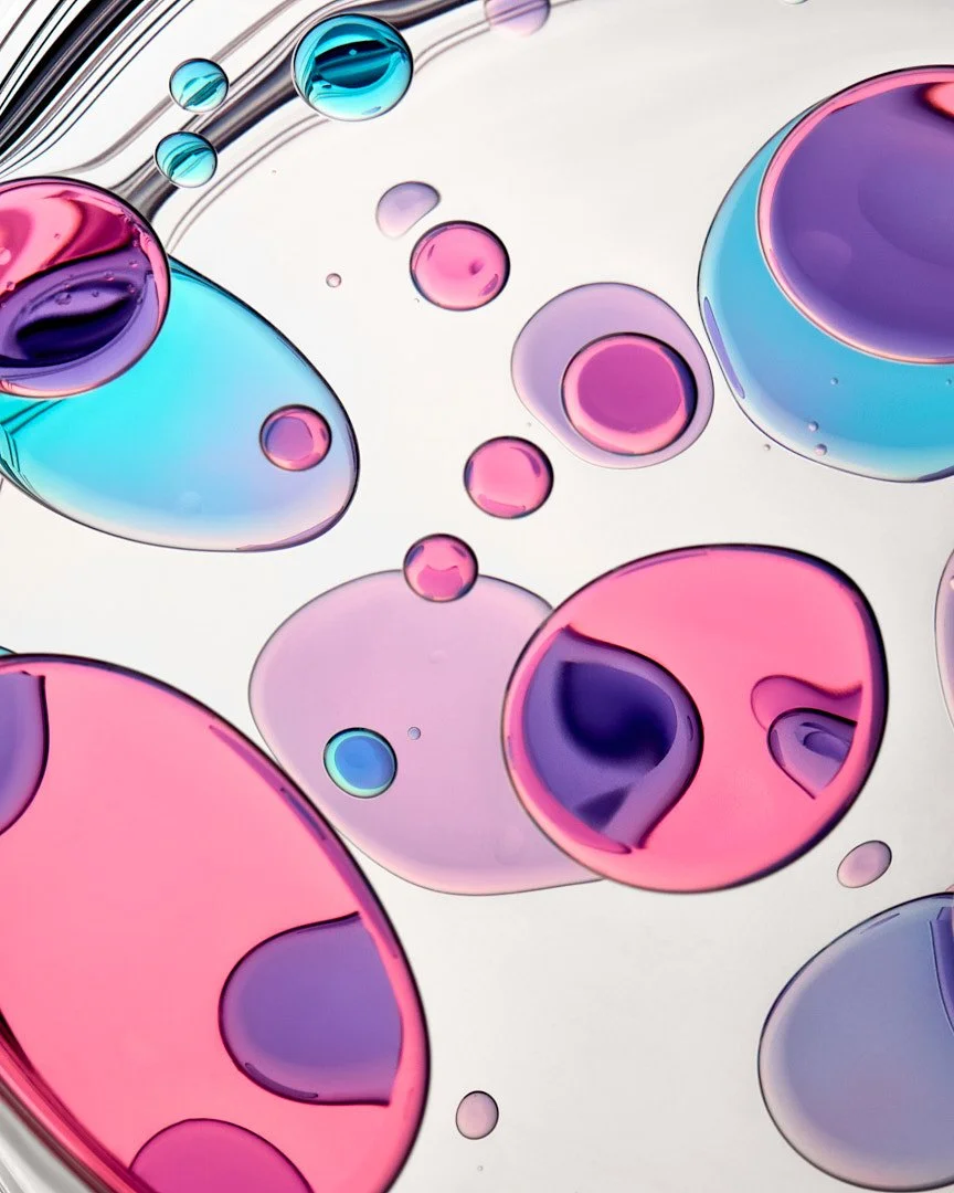 Abstract macro shot of pink, blue, and purple gel bubbles, by Adrianna Favero.