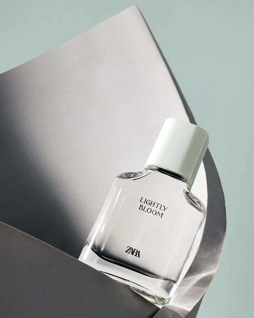 "Lightly Bloom" by Zara perfume still-life by Adrianna Favero, NYC-based still life and beauty photographer. Featuring elegant composition and refined lighting to highlight modern fragrance design—ideal for luxury campaigns, product launches, and edi