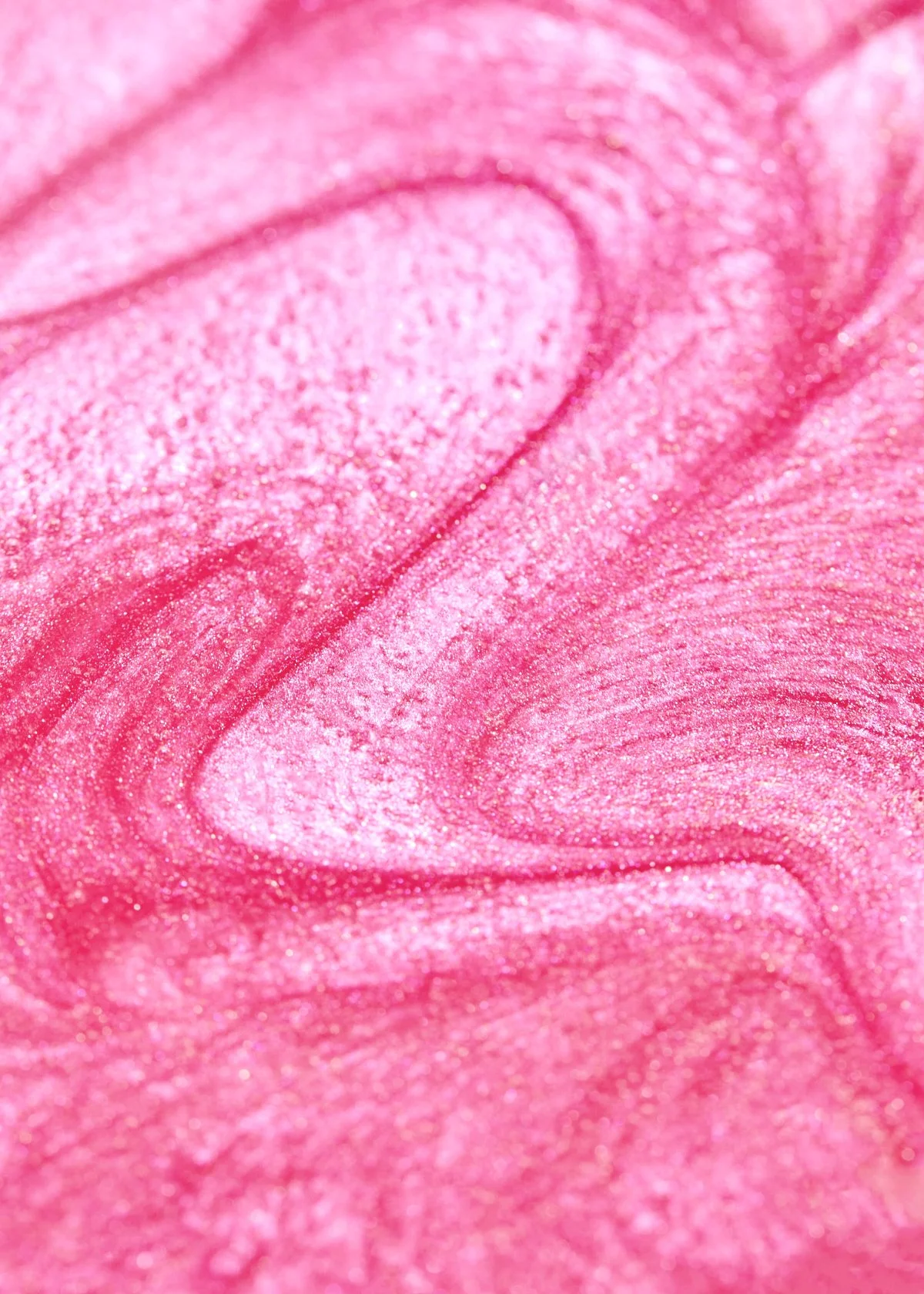 Close-up texture shot of swirled pink glittery makeup, by Adrianna Favero.