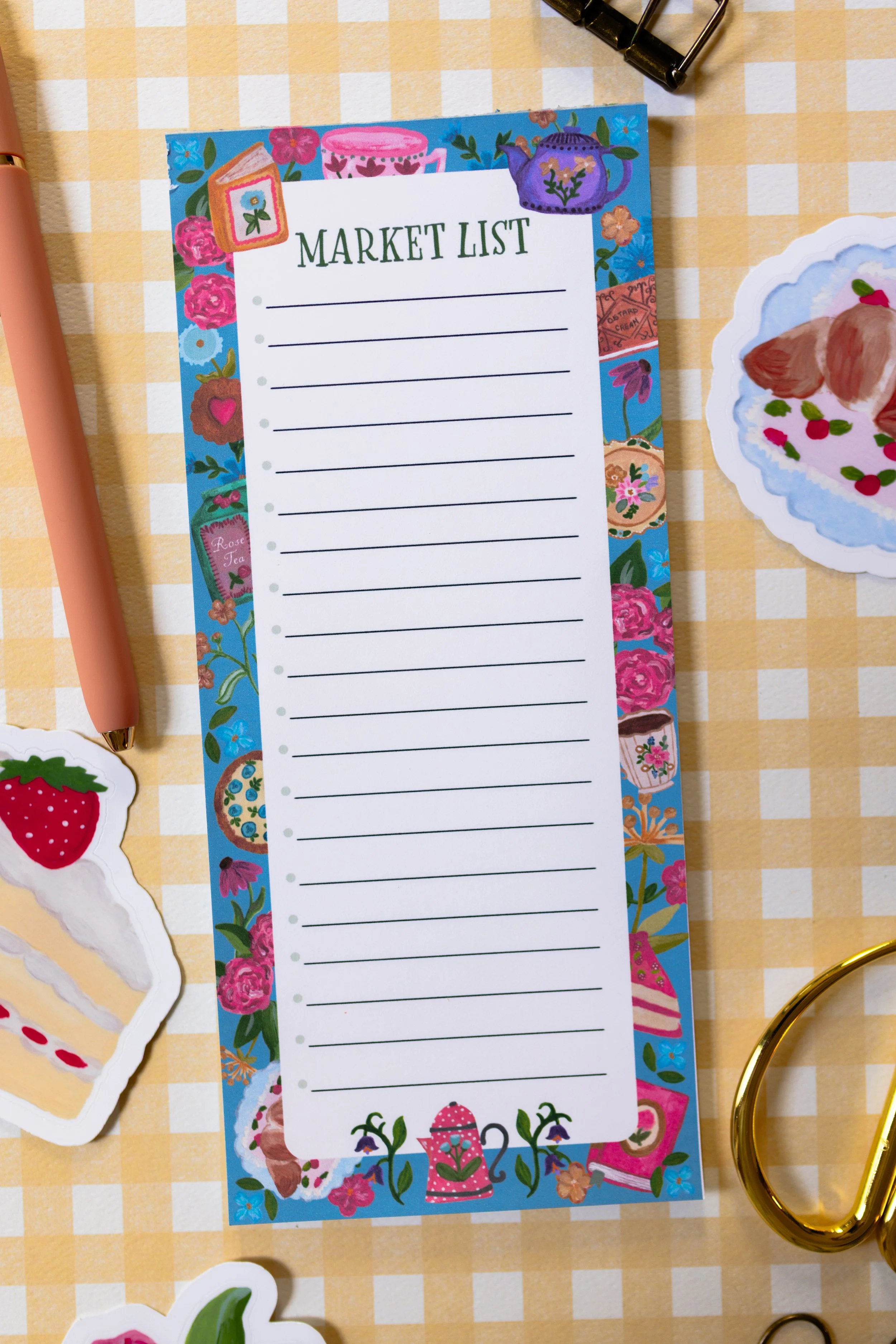 Grocery list notepad with ruled pages and colorful bookshop-inspired illustrations for meal planning and shopping lists.