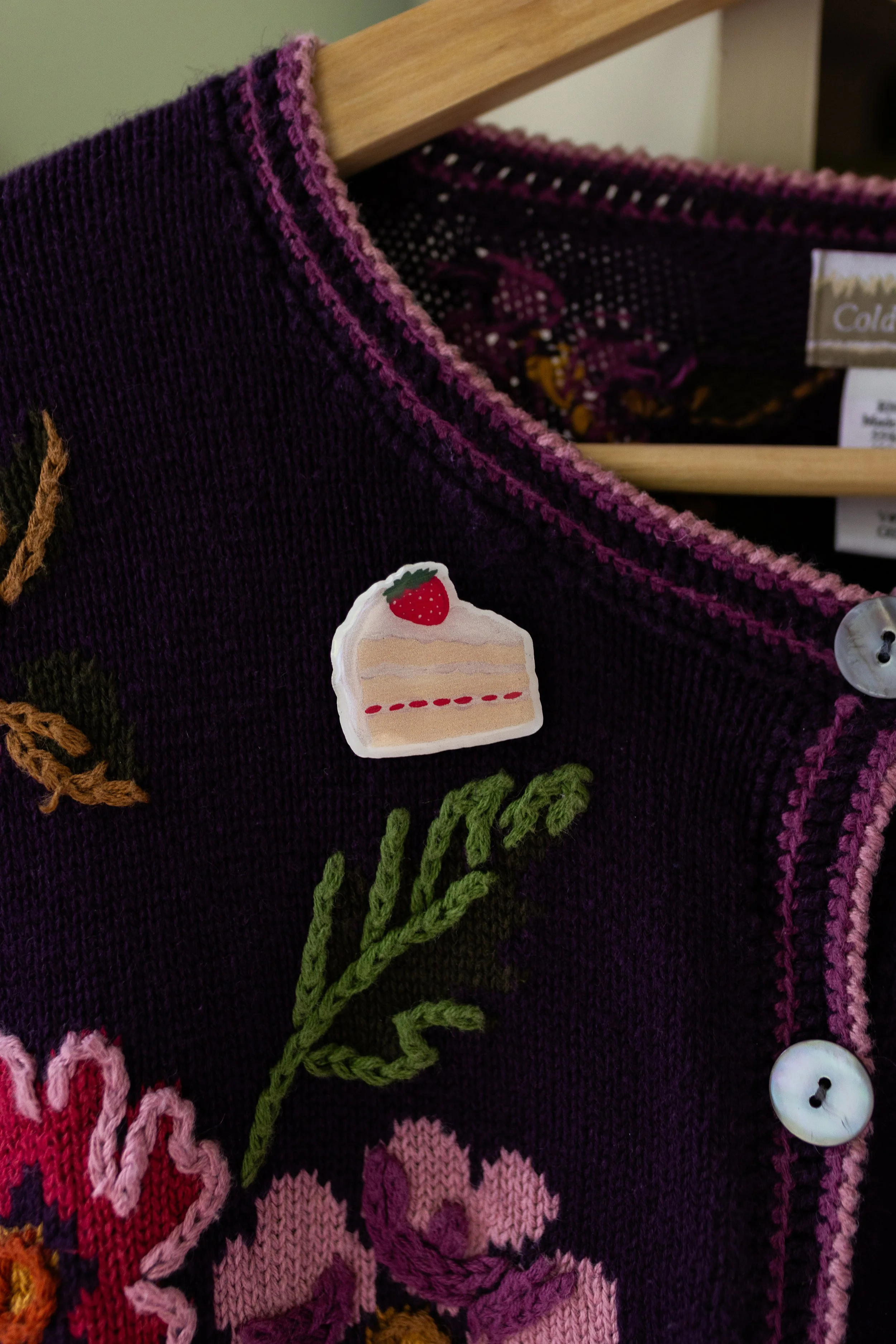 Strawberry Shortcake wooden pin featuring an original hand-illustrated slice of strawberry cake with whipped cream.