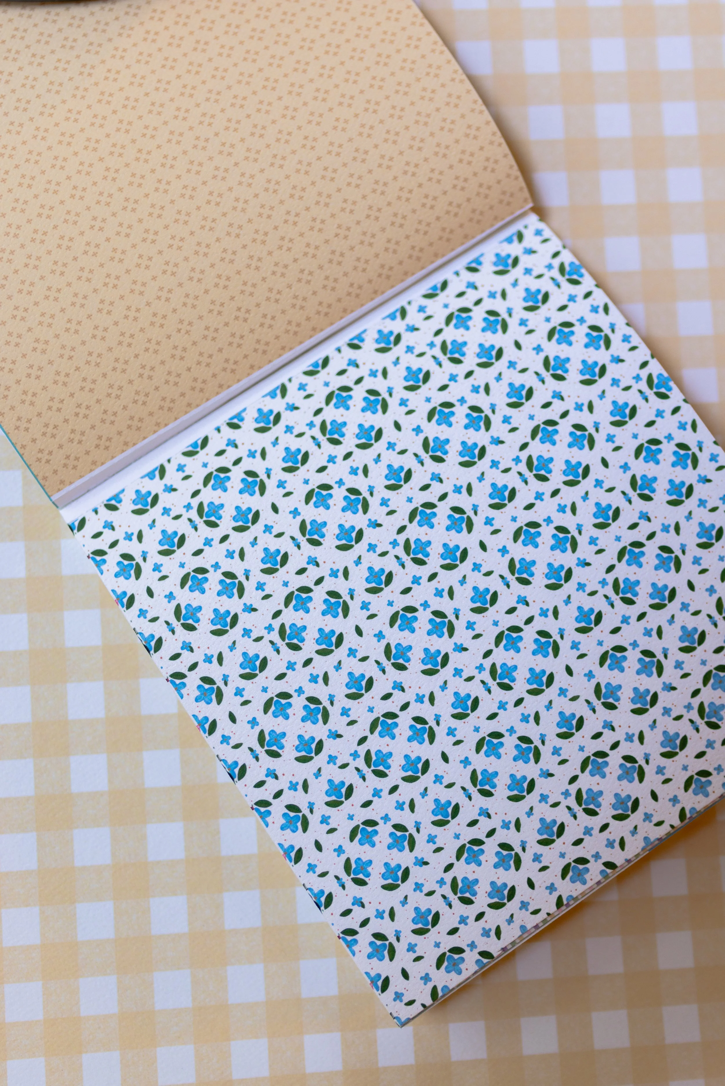 Double-sided 6x6 scrapbook paper pad with perforated tear-out pages for crafting and journaling.
