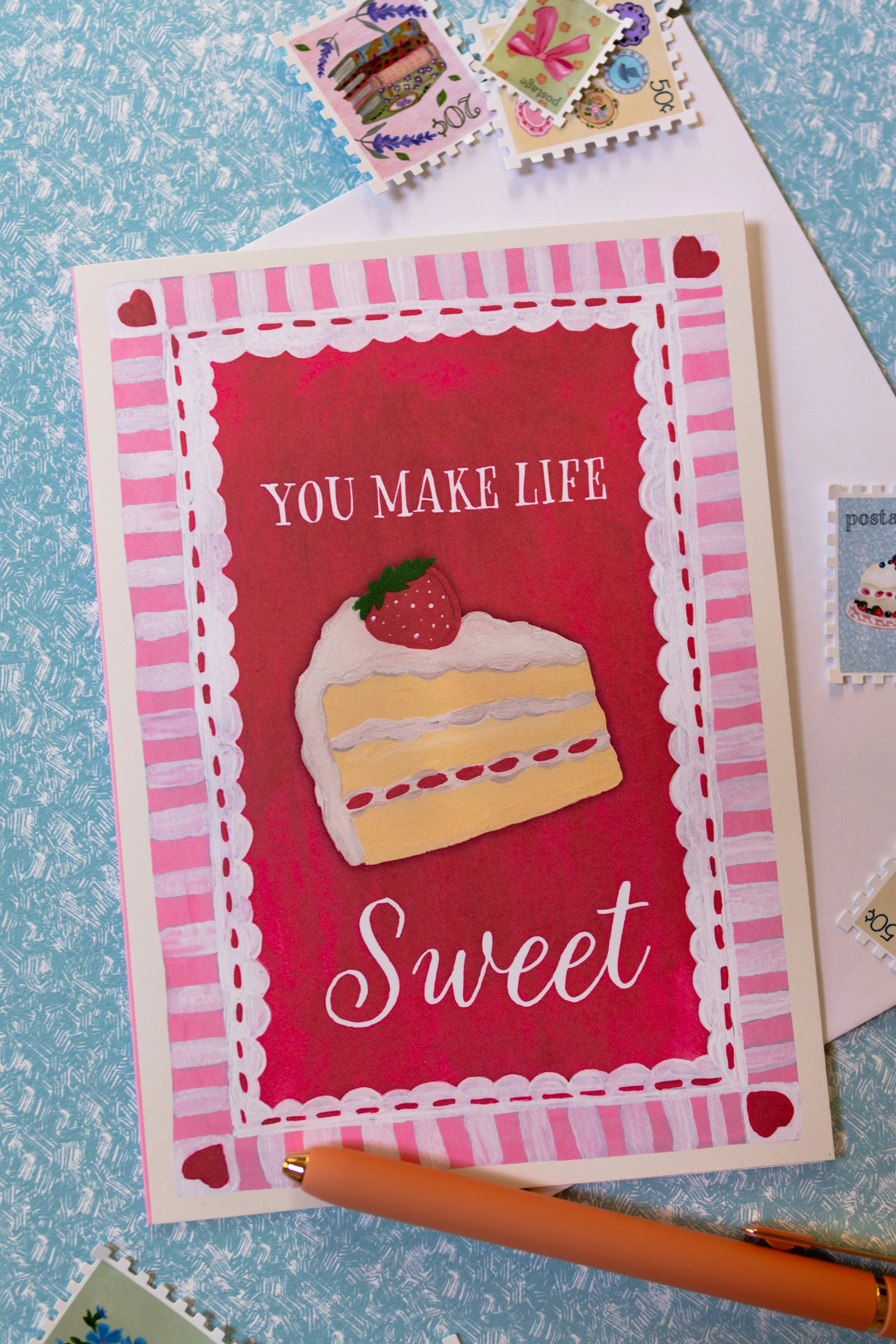 Dessert greeting card with pink striped border and hearts.