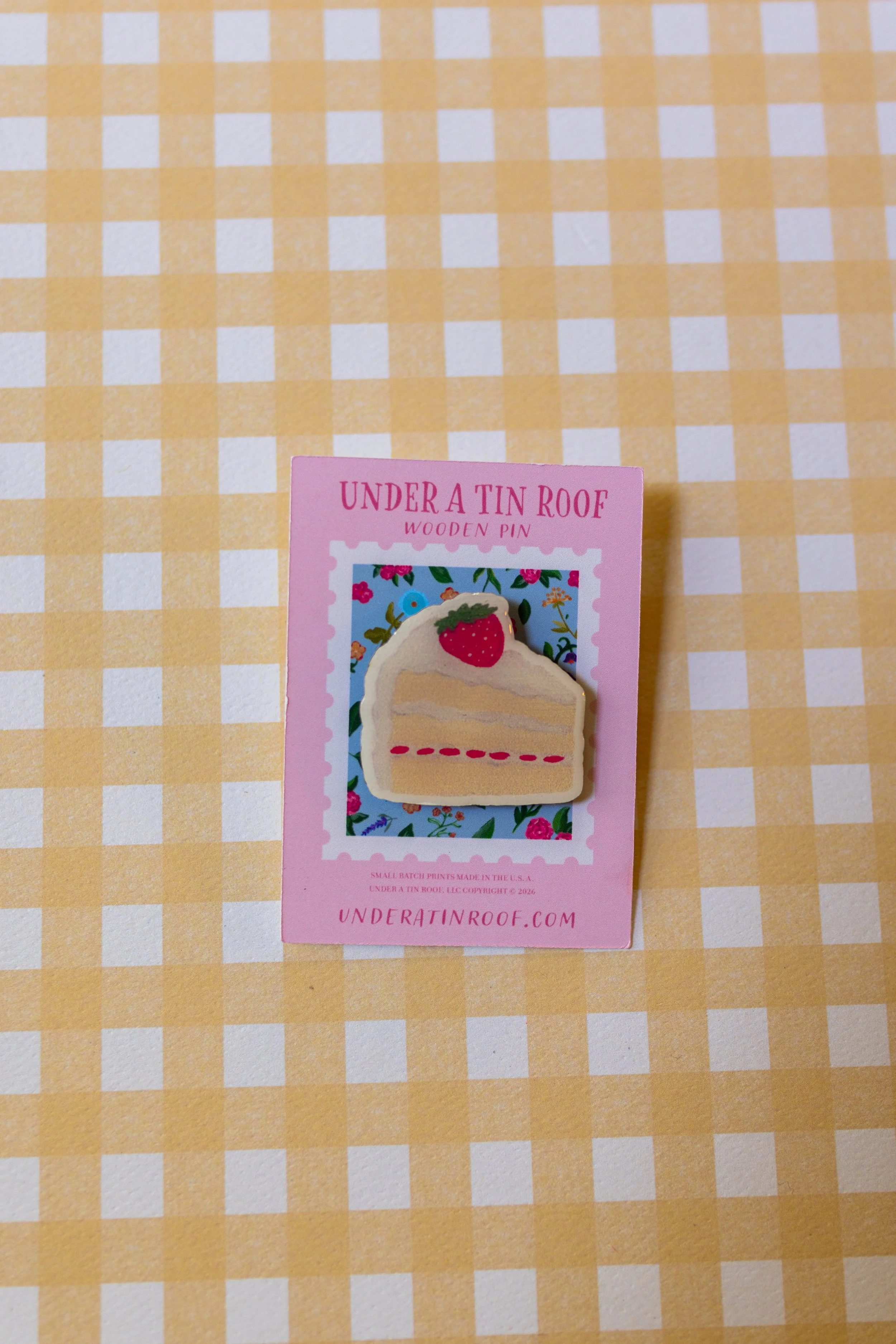 Artist-designed dessert wooden pin displayed on branded backing card with glossy UV resin finish.
