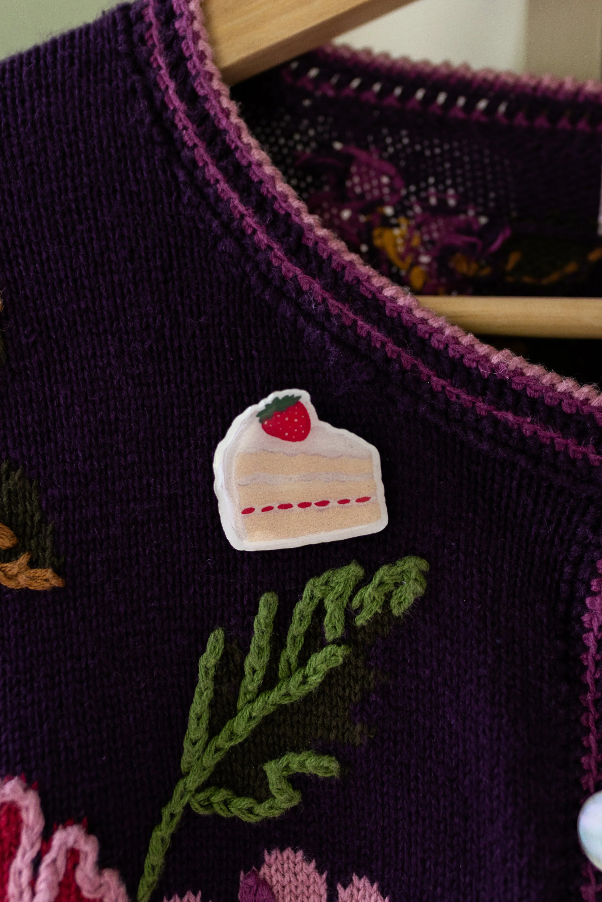 Strawberry Shortcake wooden pin featuring an original hand-illustrated slice of strawberry cake with whipped cream.