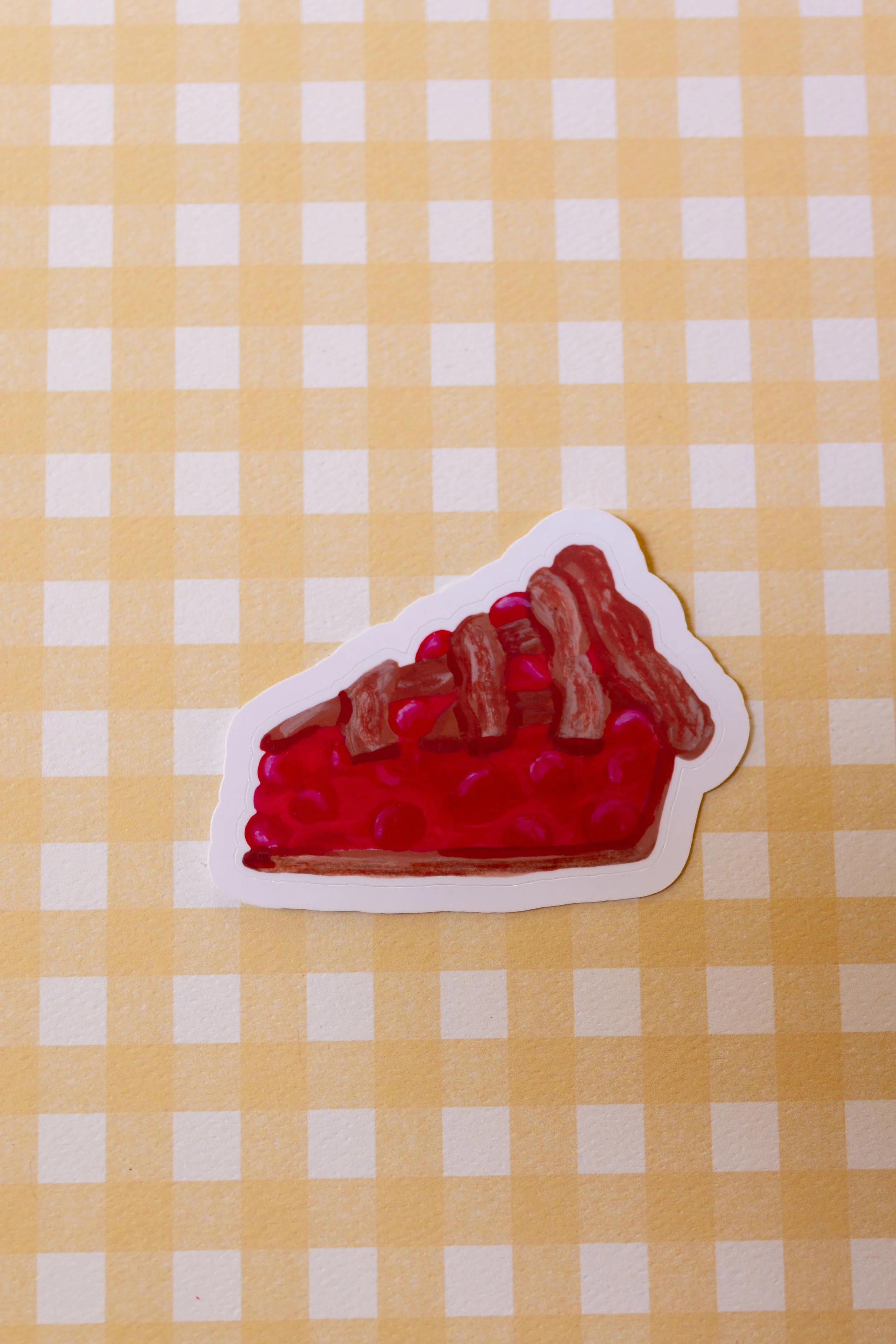 Delectable piece of cherry pie die cut sticker.