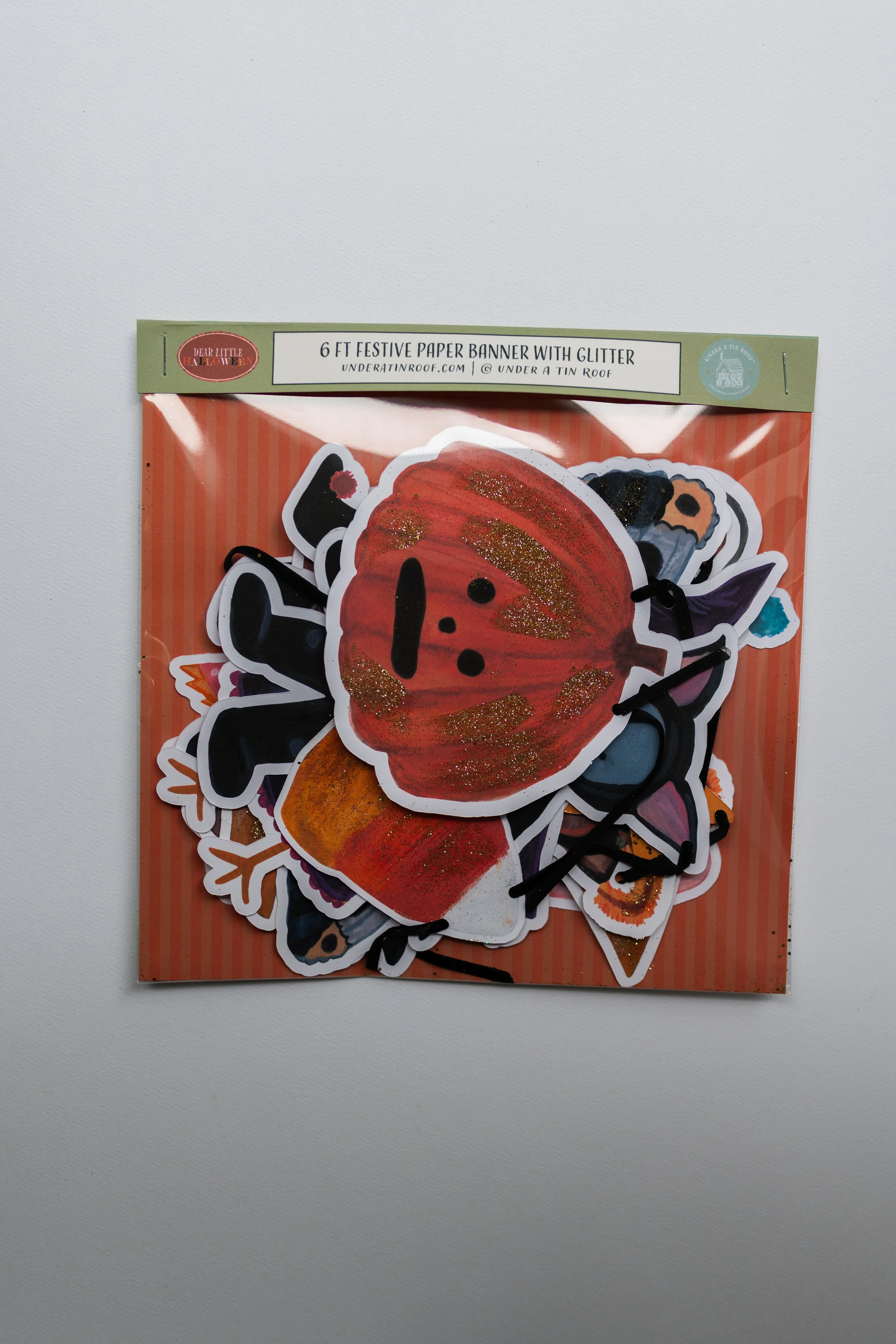 6-foot Pumpkin Hollow Halloween paper banner featuring illustrated costumed animal characters, pumpkins, bats, moons, stars, and candy corn on black velvet ribbon.