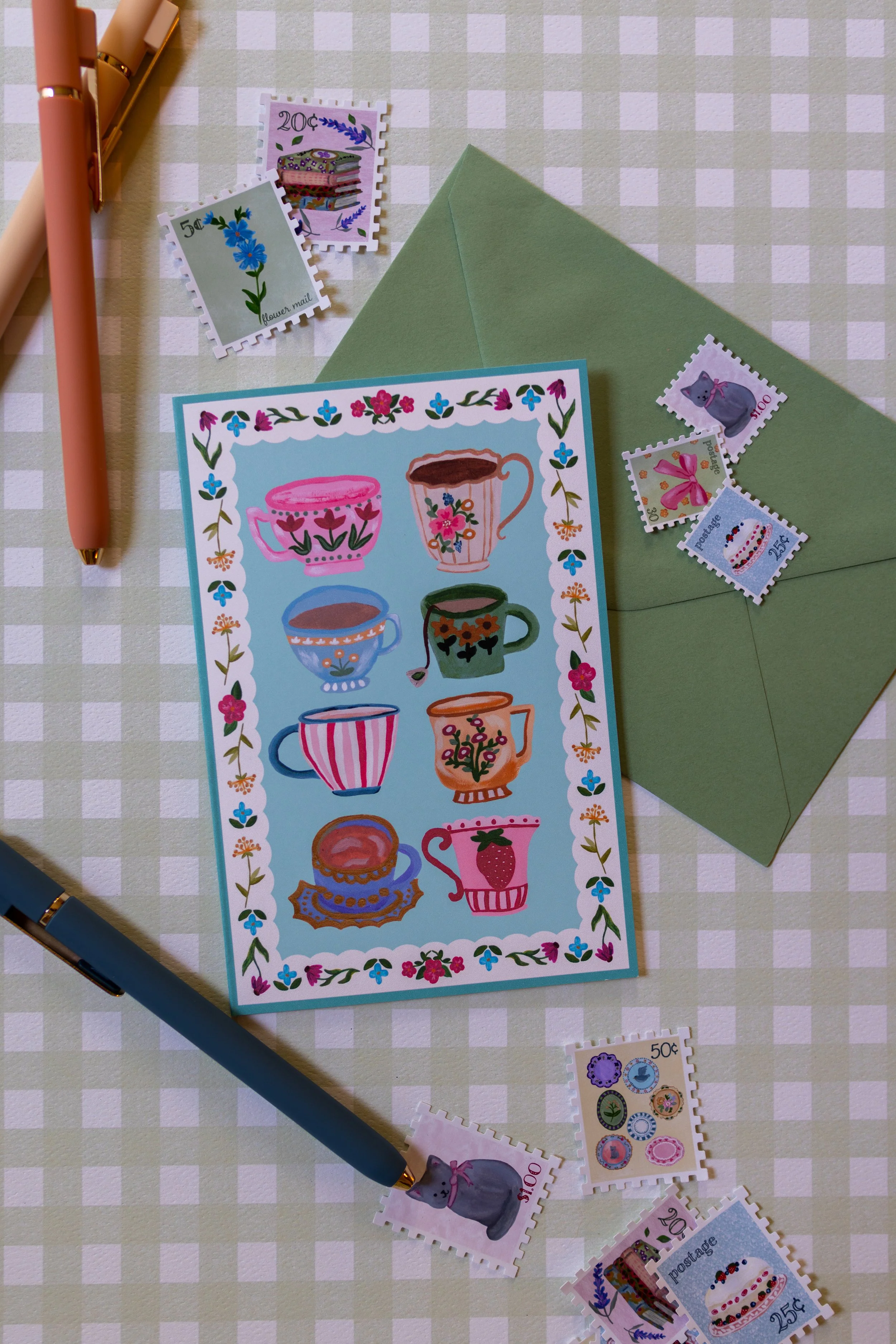 Floral teacup greeting card featuring colorful illustrated teacups on a teal background.
