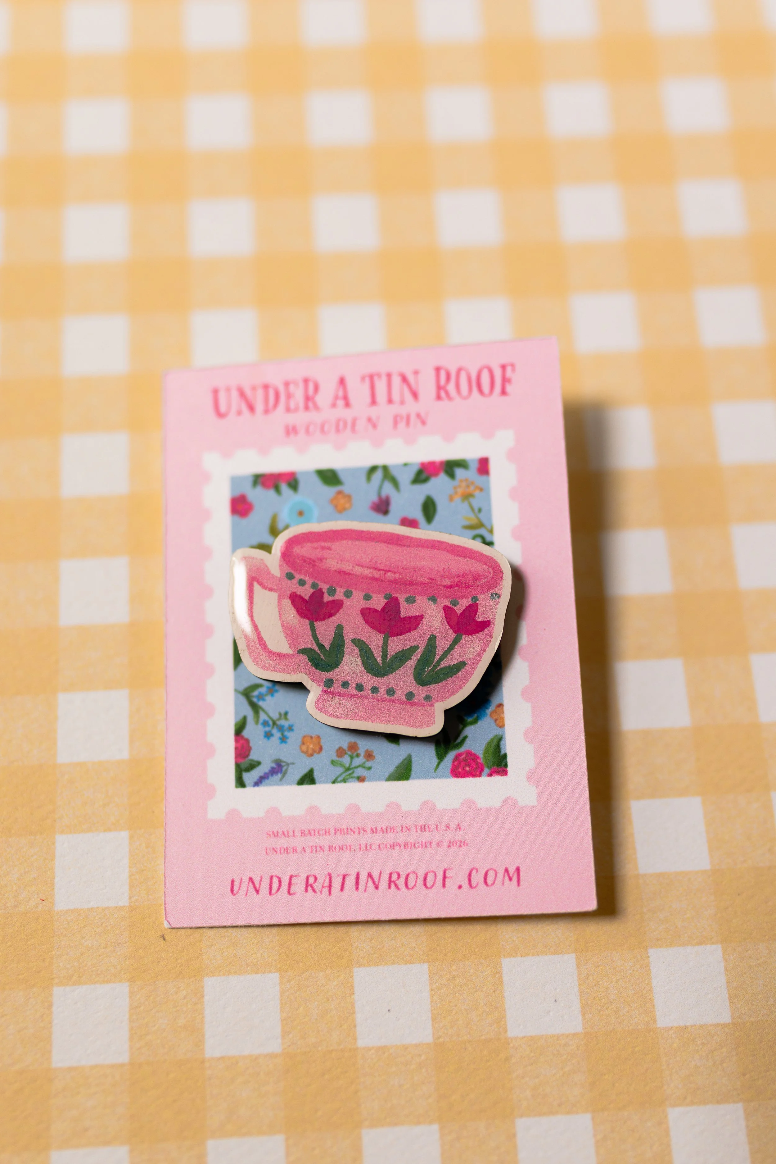 Artist-designed tea lover wooden pin with glossy UV resin finish displayed on branded backing card.