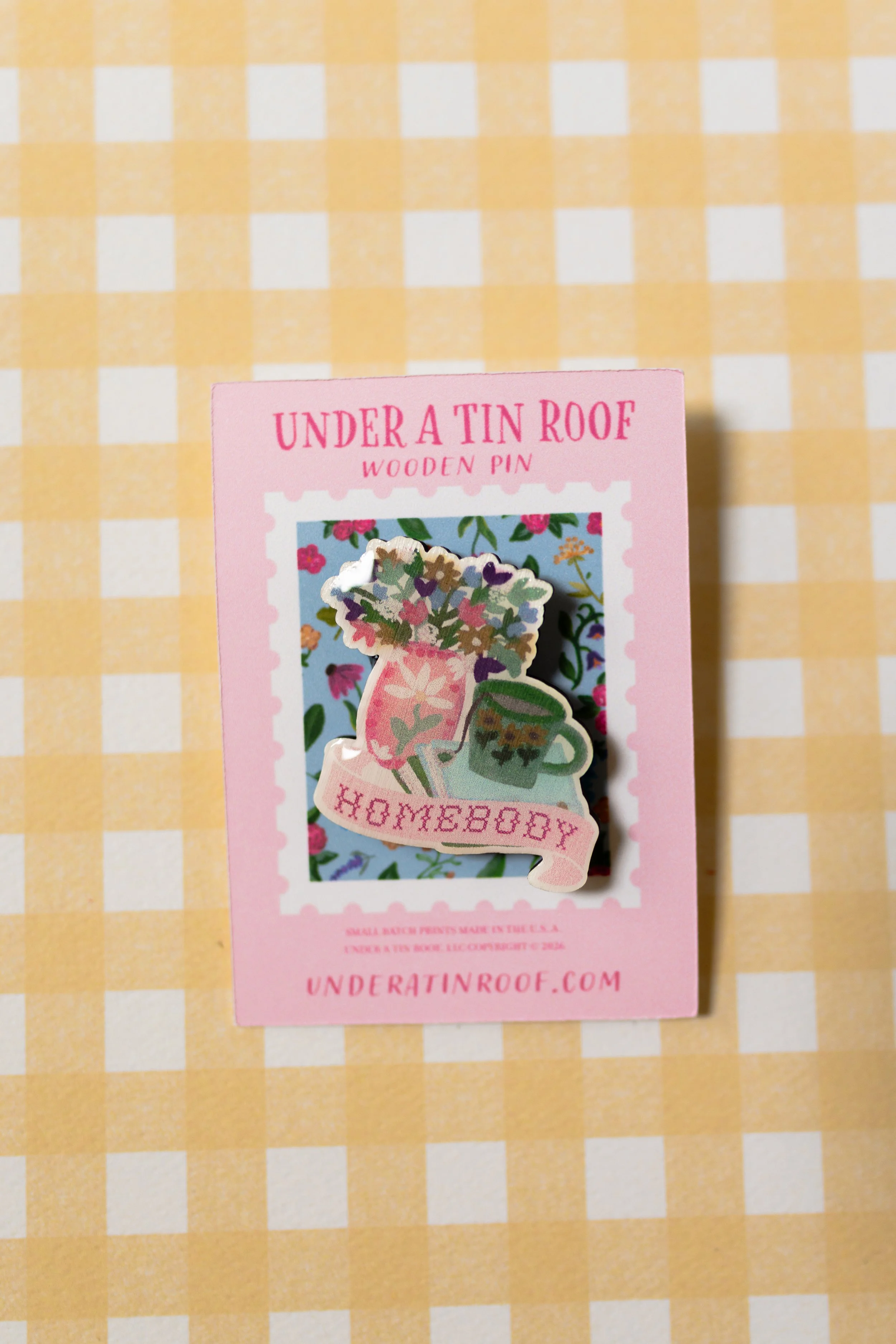 Artist-designed wooden pin celebrating cozy home life, gardening, books, tea, and slow living.