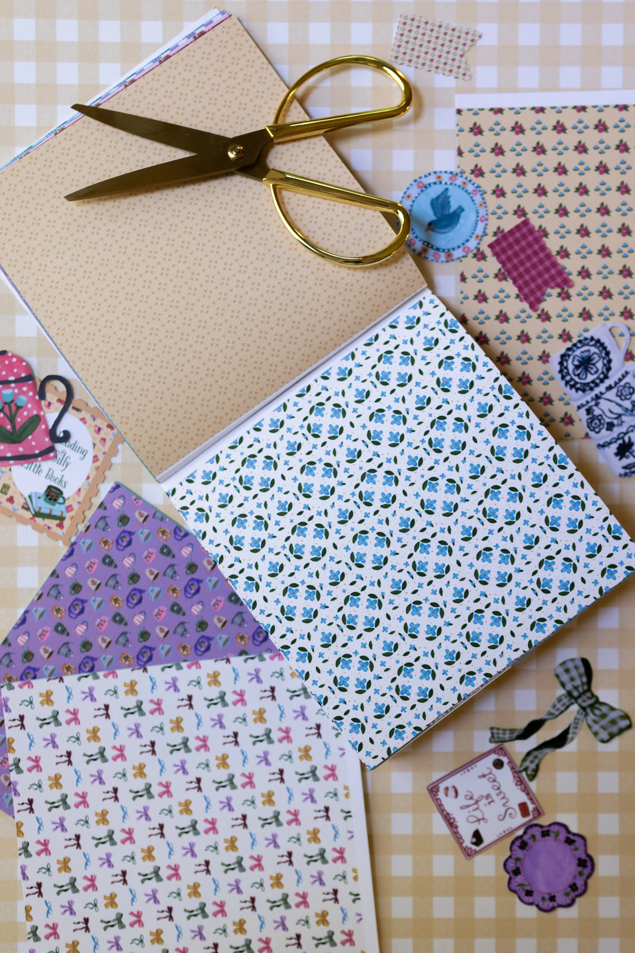 Artist-designed paper pad with floral, book, teacup, dessert, gingham, and vintage-inspired scrapbook papers.