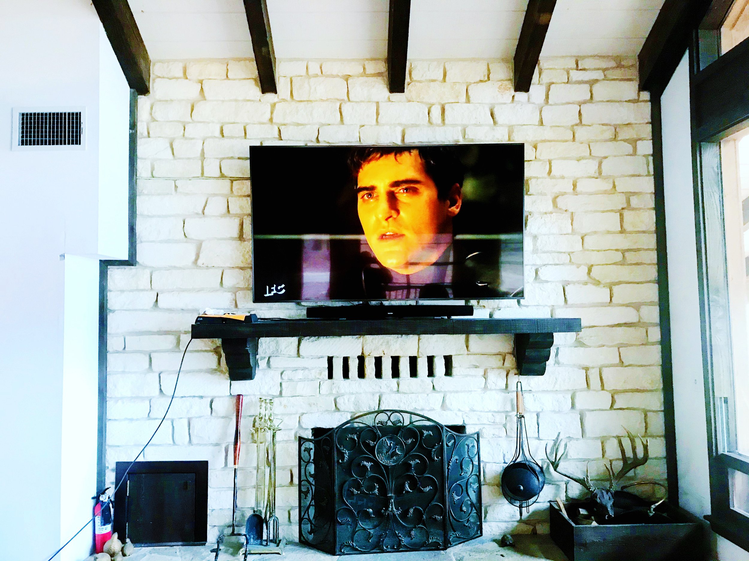 75' 4K TV mounted above the mantle into stone.