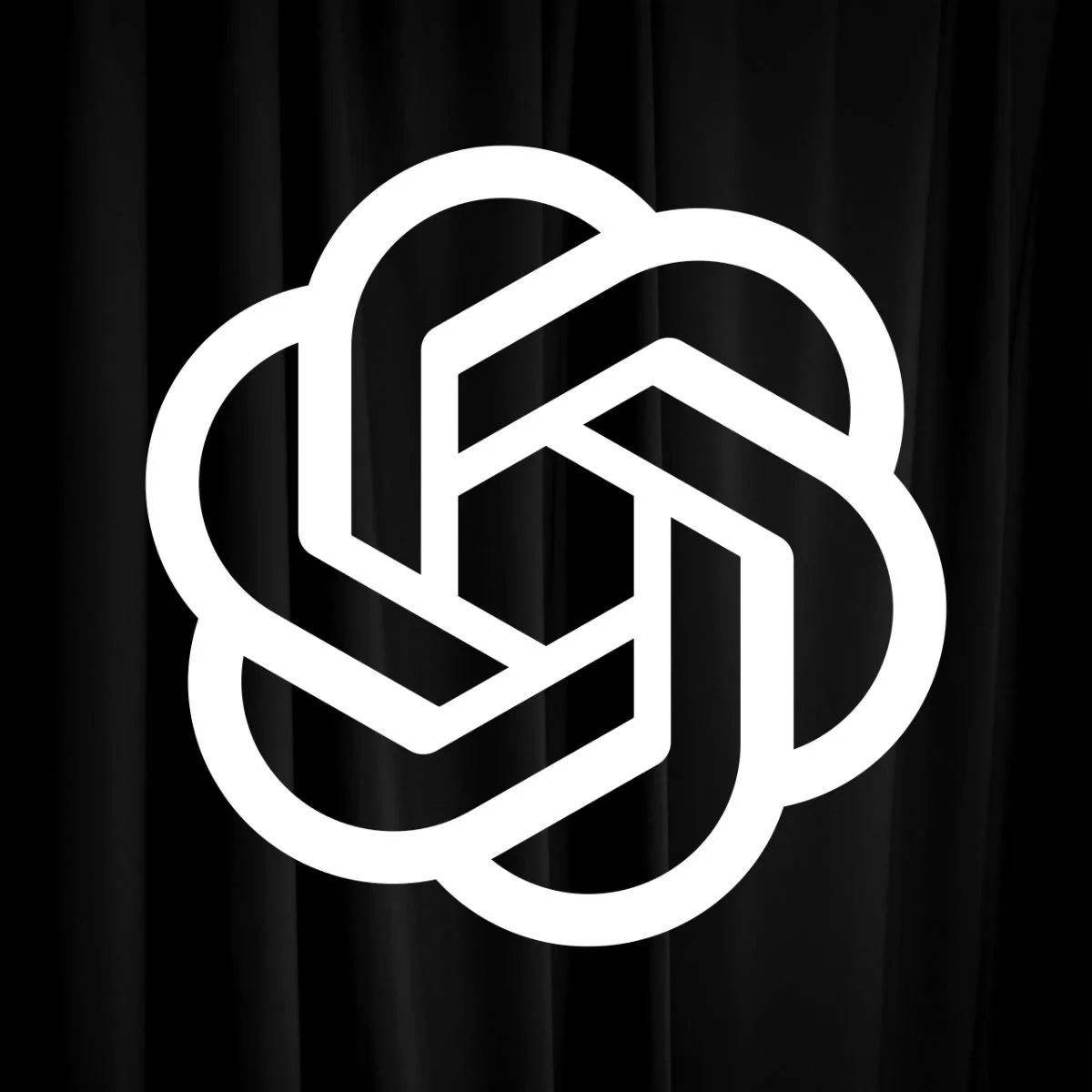 White geometric OpenAI logo on a black background representing the company's focus on artificial intelligence research and innovation.