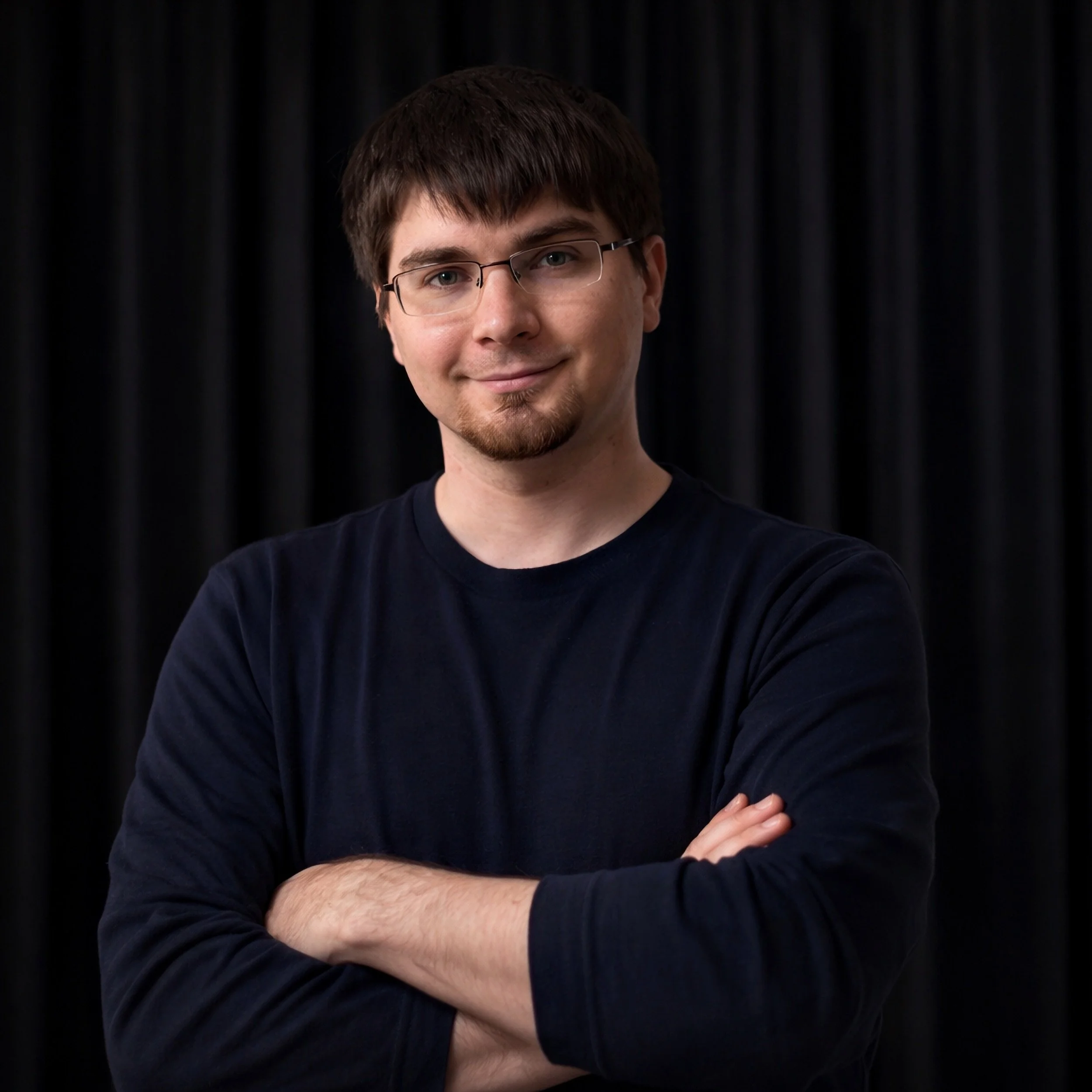Portrait of Ian Goodfellow, AI researcher and inventor of Generative Adversarial Networks, shown against a dark studio background.