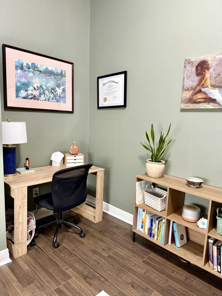 office space commercial office rental private office boutique rental chair desk wooden bookshelf with art on the walls green walls wooden desk