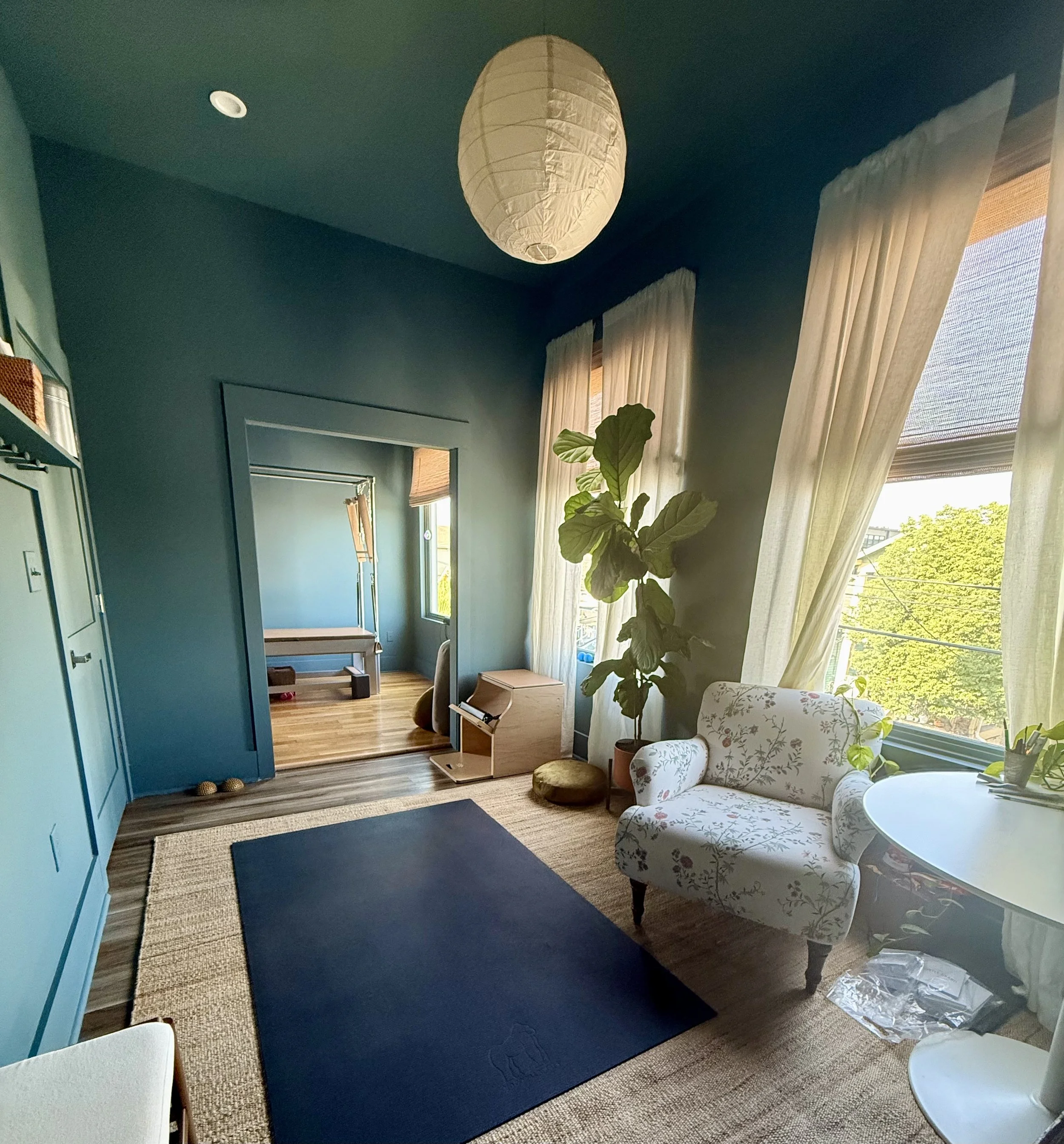 office space for rent new orleans white curtains white lantern hanging from ceiling white armchair and table black rug wood floors