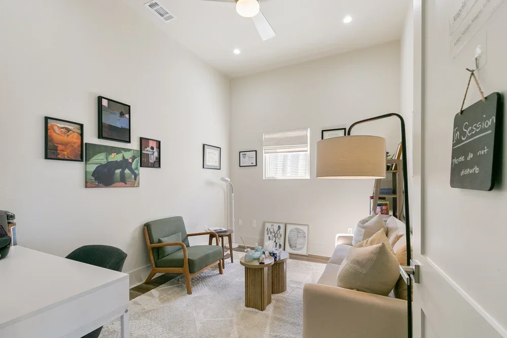 commercial office space rental new orleans boutique rental private office lamp white rug beige couch green armchair white desk ceiling fan framed art natural light