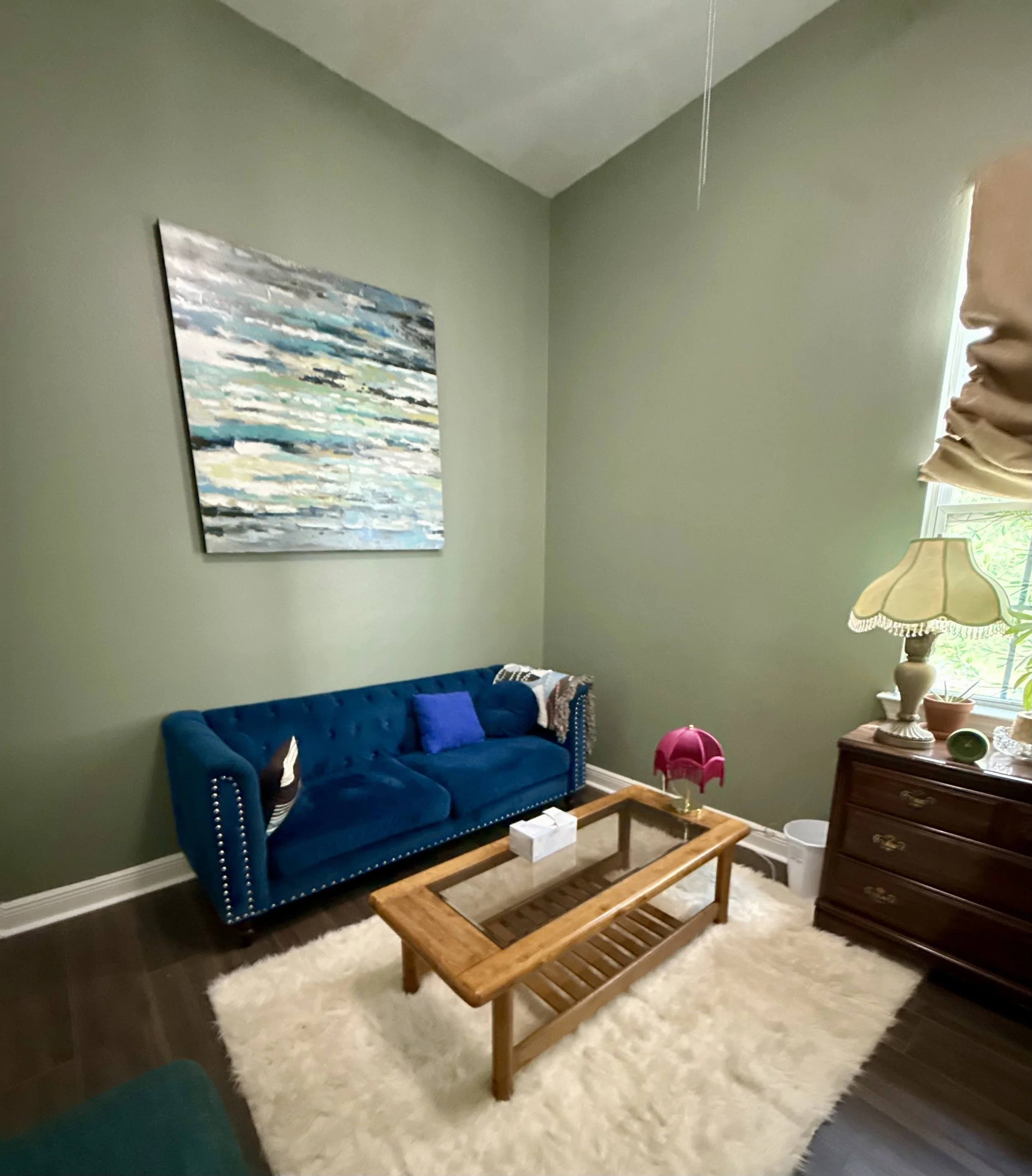 office space for rent new orleans blue couch with a white rug and wooden coffee table with abstract blue art hanging above