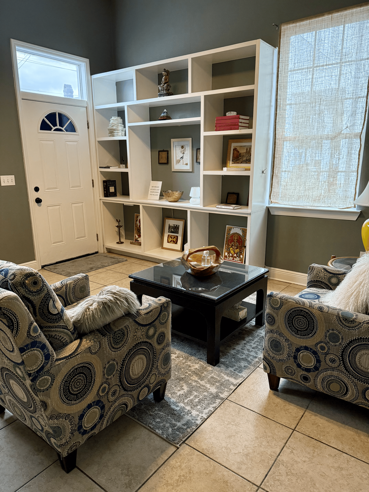 office space lobby armchairs blue and gray with a blue rug and open shelving with open white boxes and green walls and linen curtains commercial office space rental private office waiting room 