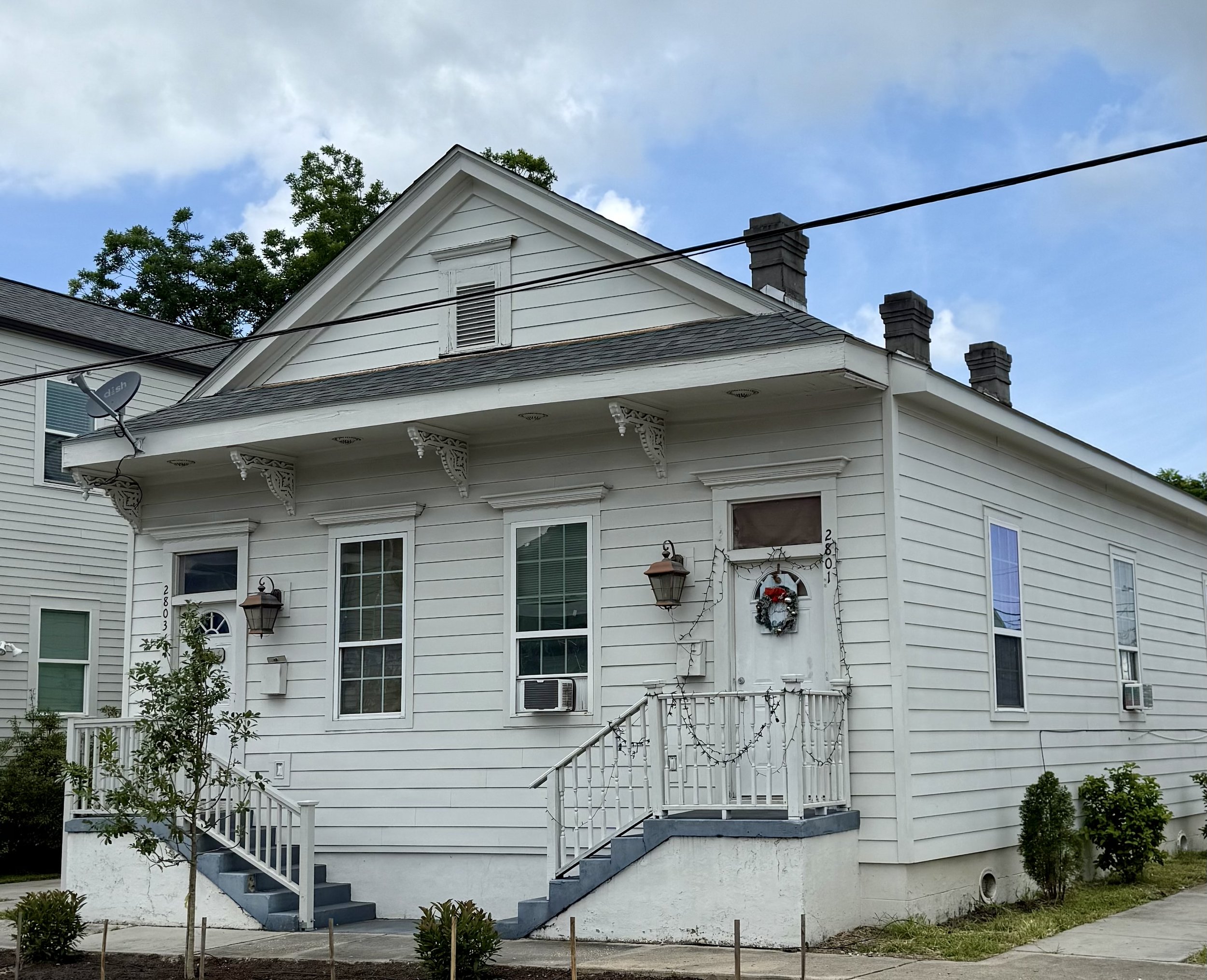 exterior Conti Street office buildings for rent new orleans white shingle cottage with blue stairs