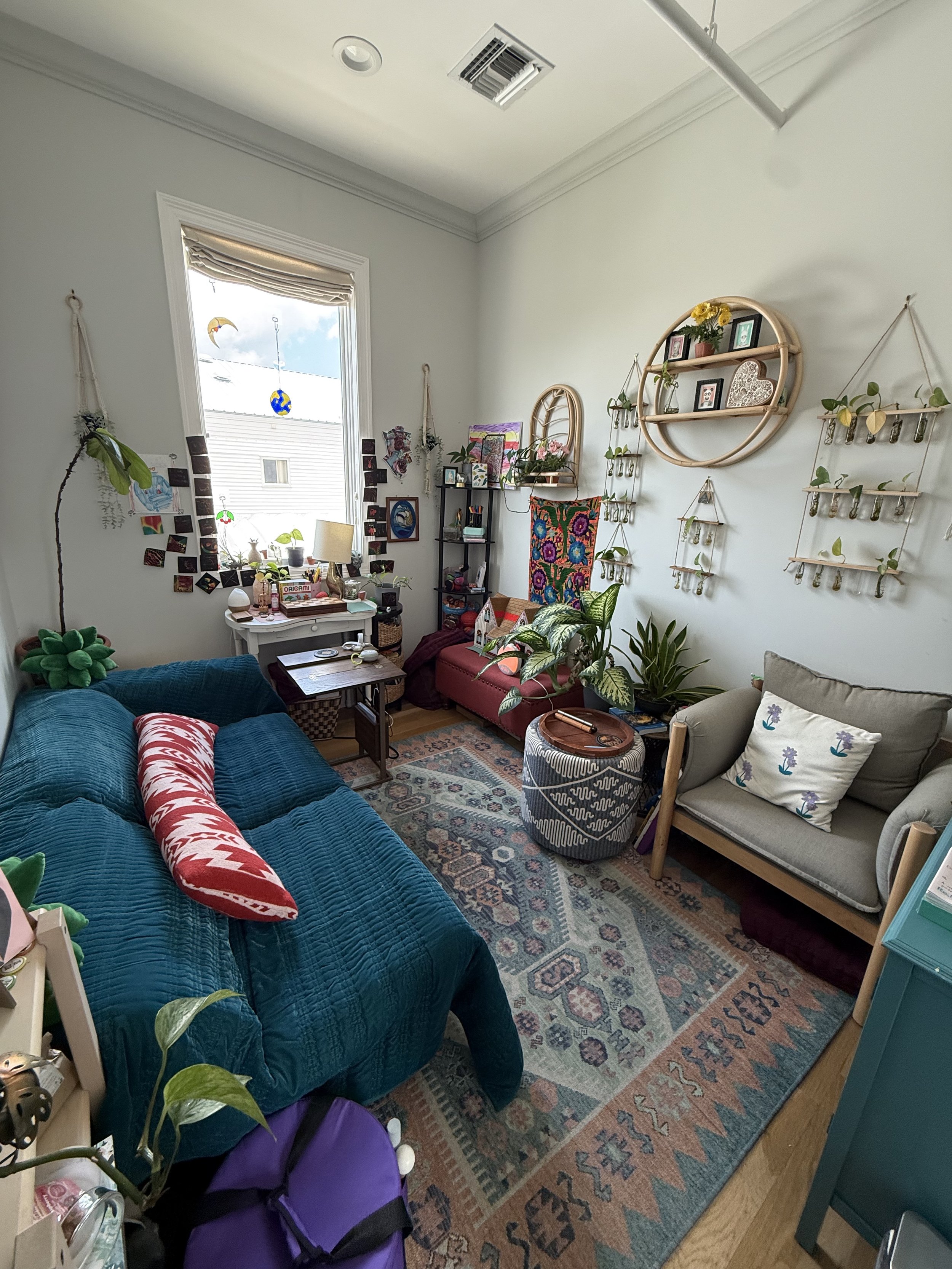 suite 204 office space for rent new orleans colorful rug blue couch red pillows bohemian decor wall hangings plants window white walls
