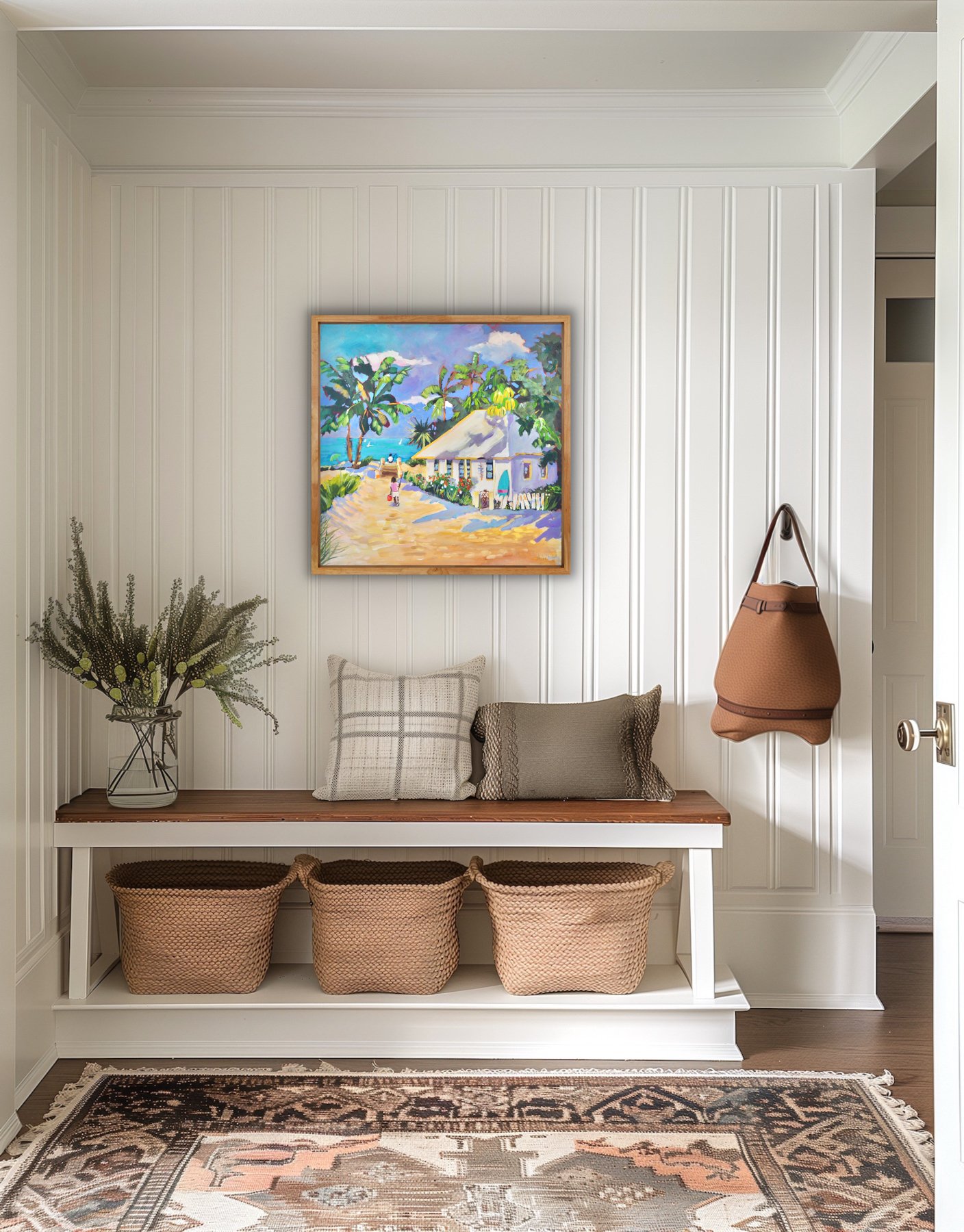 Sandy Track coastal painting displayed above a bench in a neutral entryway