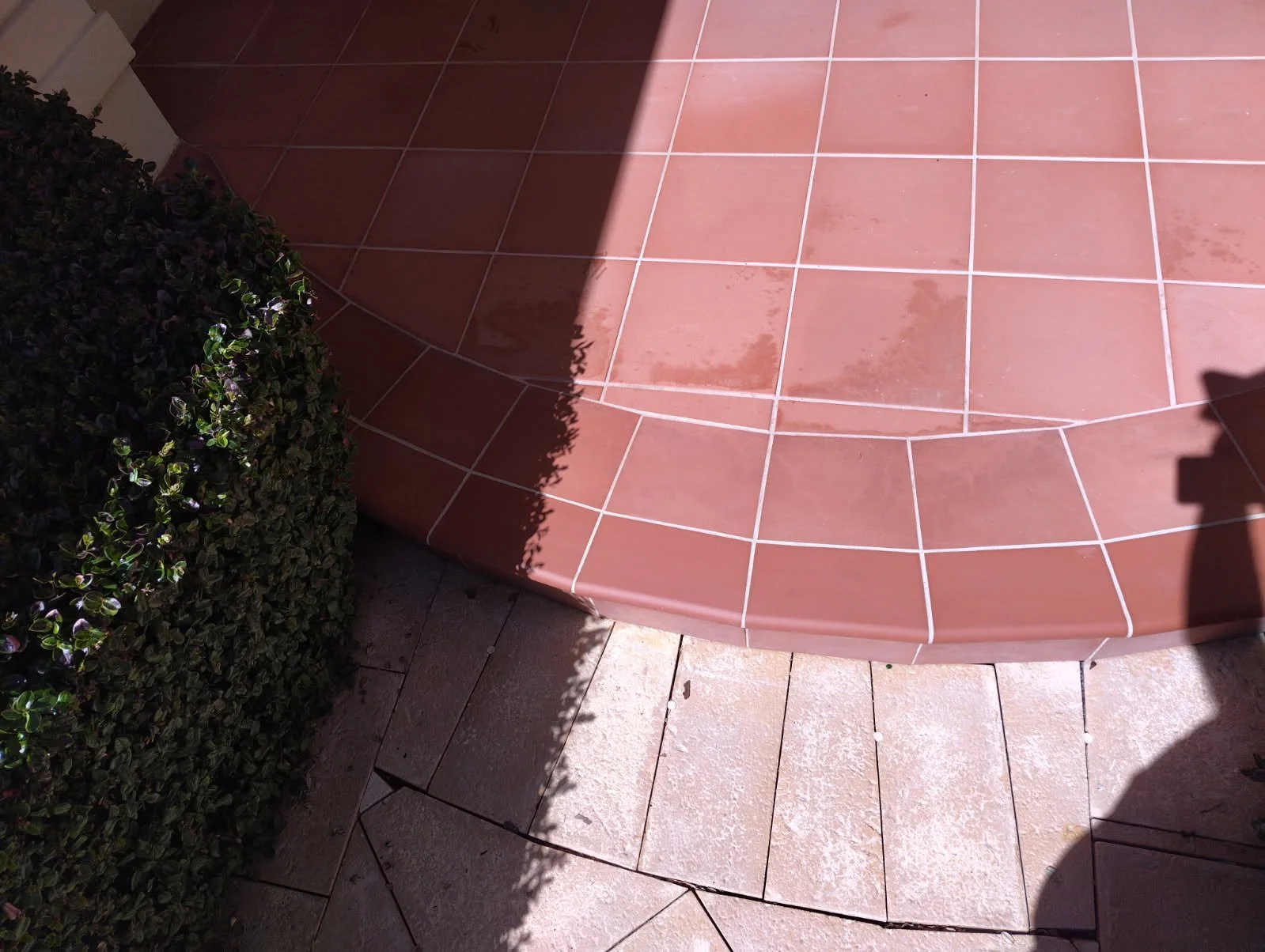 Close-up of a curved terracotta-tiled outdoor area with tiles matched from the tile library