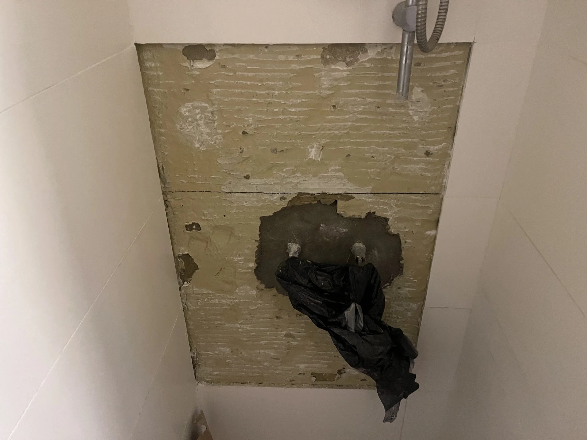 Bathroom shower taps being replaced requiring 300x600 white gloss discontinued tiles