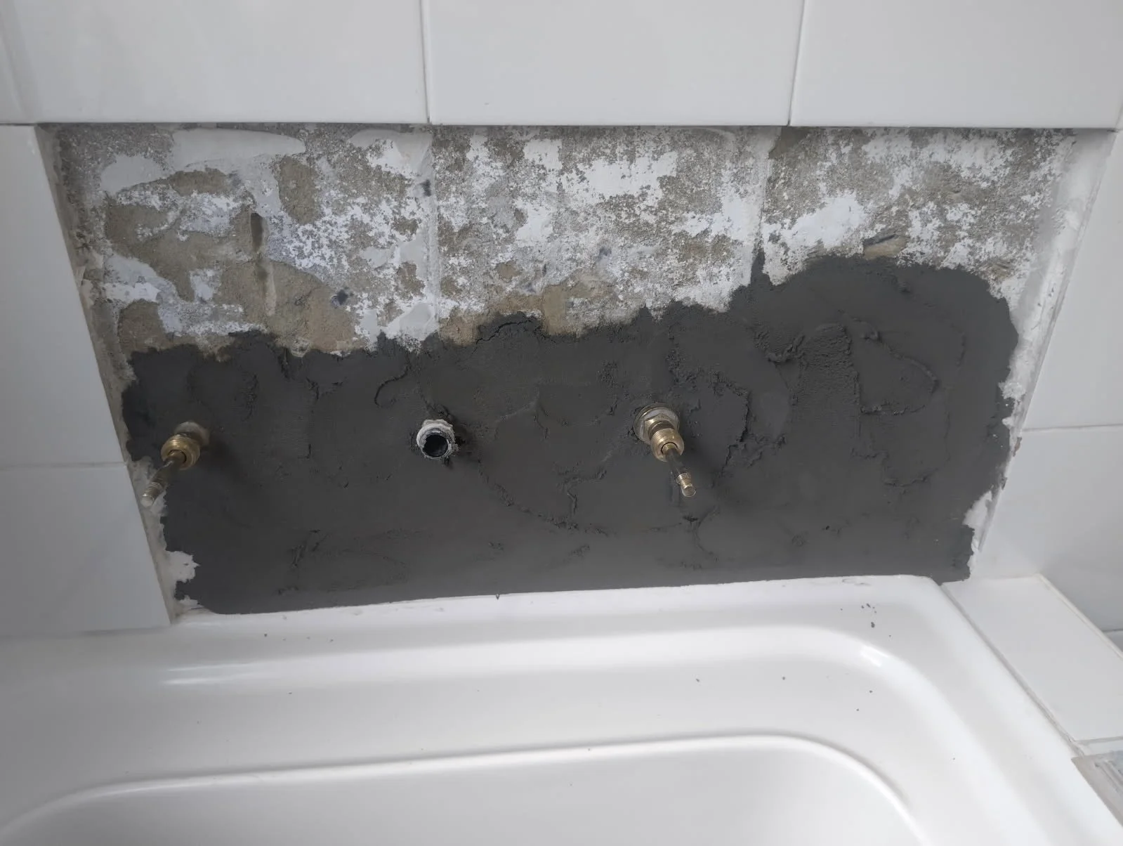 Bathroom iplex pipe plumbing repair requiring discontinued tiles to be matched.