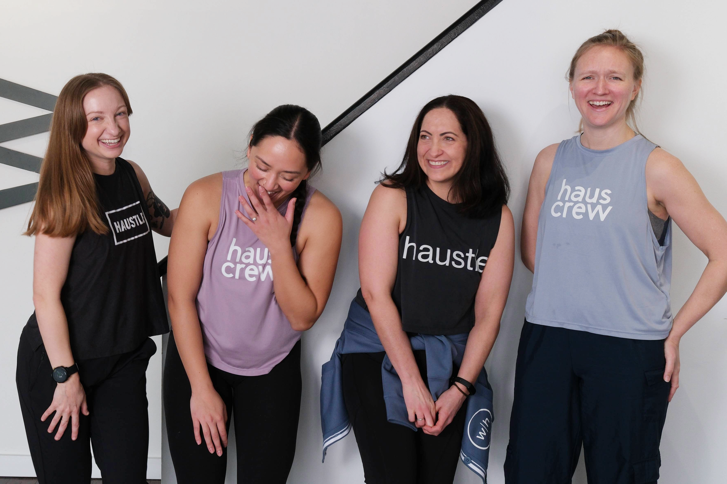 Four women smiling and laughing.