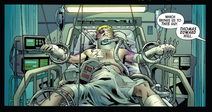 Tommy laid back in a hospital bed, bruised in distinct purple, with layers and layers of equipment keeping him alive. Detective Mayes says from off-screen: "Which brings us to this guy. Thomas Edward Hill."