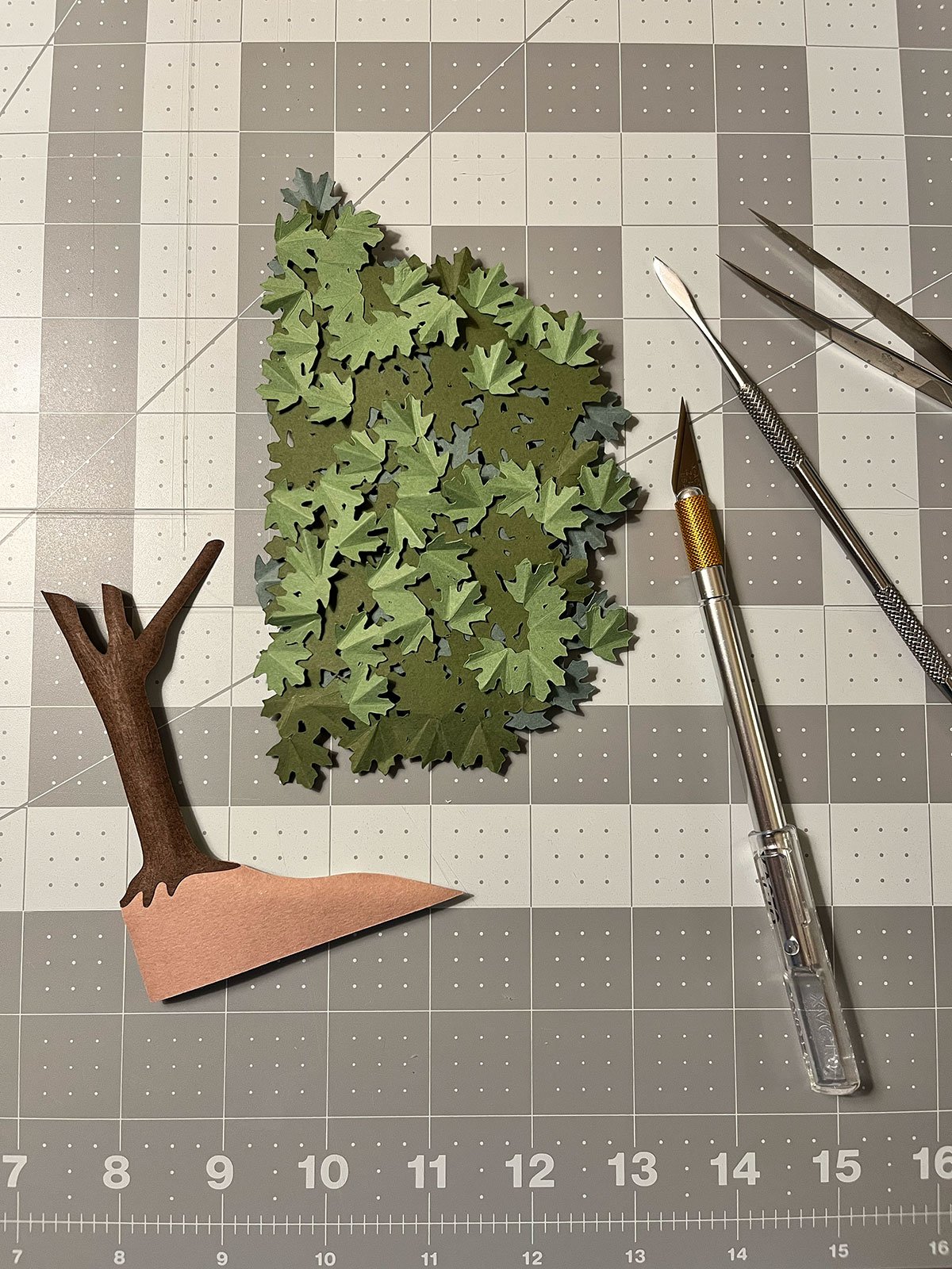Photo of cut paper and cutting tools taken during construction of graphic about maple syrup production