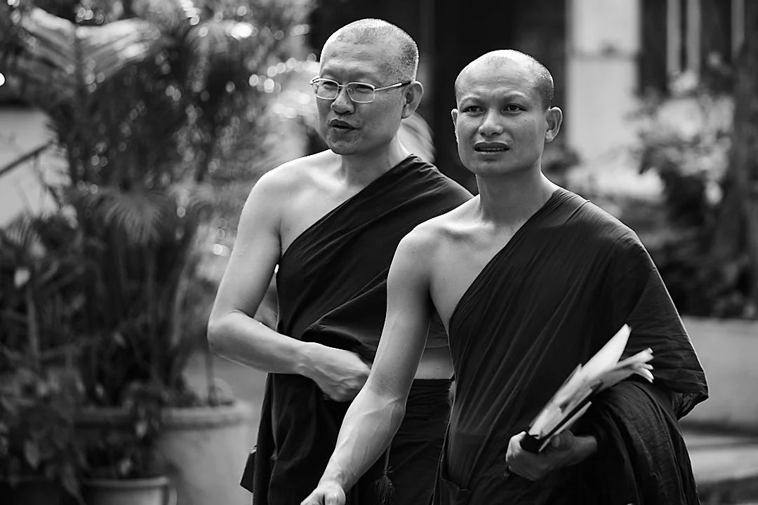 They walked in step without trying to, one carrying books, the other carrying nothing. Whatever they were talking about, it was not for the street to hear.