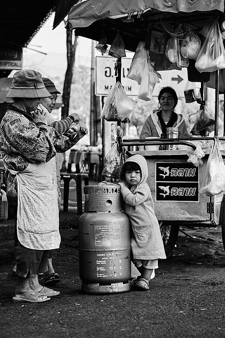 She took the call and the child found the nearest solid thing to hold onto. The street carried on around both of them.
