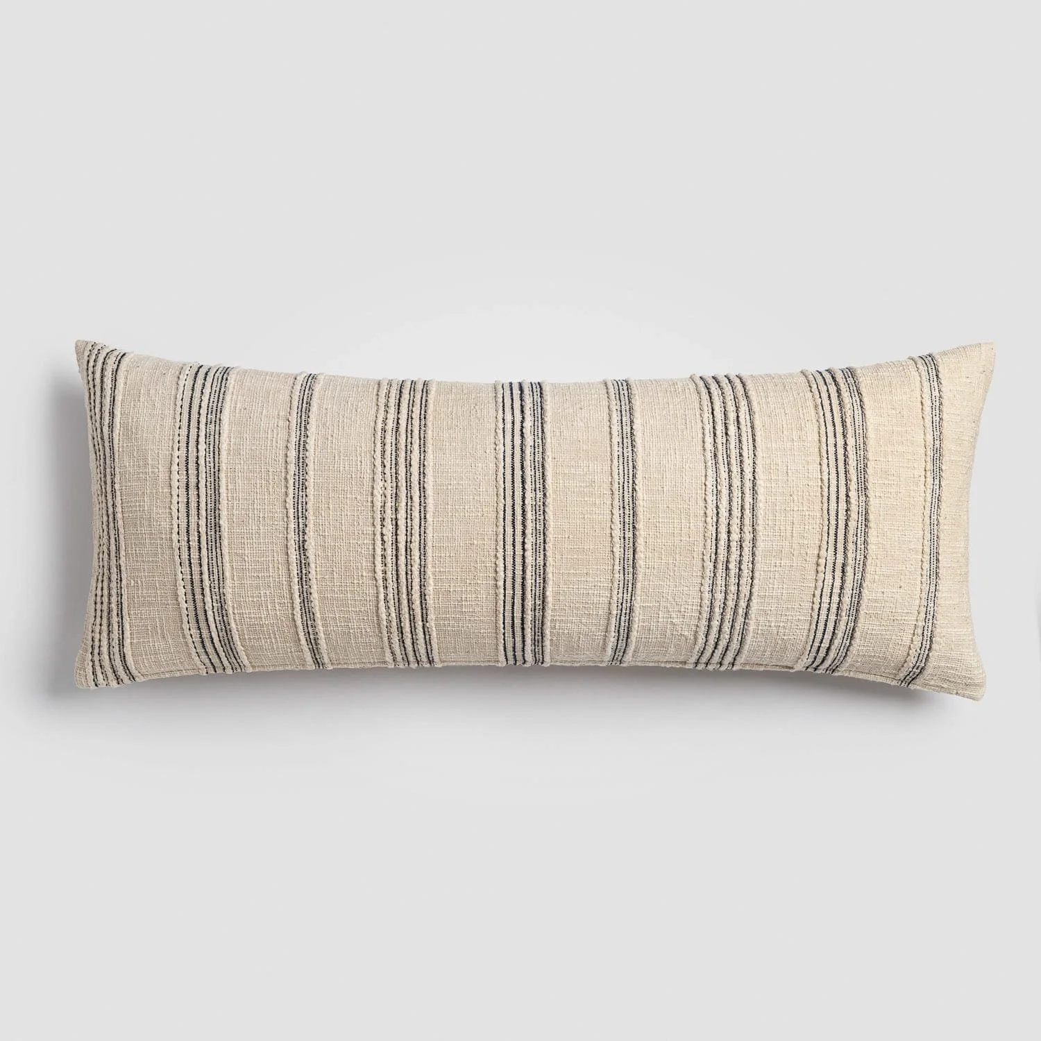 Beige rectangular decorative pillow with vertical black stripes on a light background.