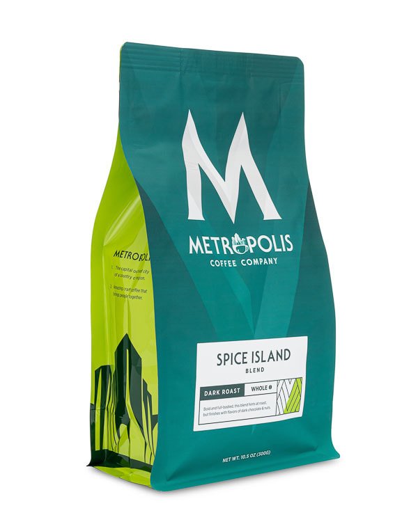 A bag of Metropolis Coffee Company's Spice Island Blend coffee with dark roast, whole beans in teal and green packaging.