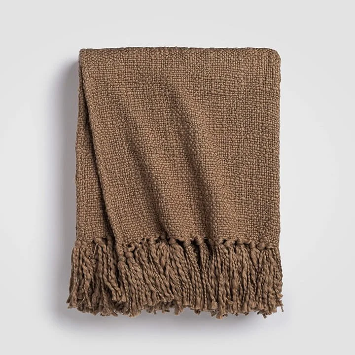 A folded brown textured throw blanket with fringed edges on a white background.