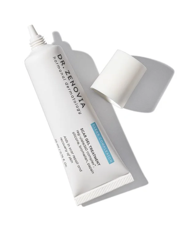 A tube of Dr. Zenovia Horionic Dermatology Scar Gel Treatment with a white applicator sponge beside it, casting a shadow on a white background.