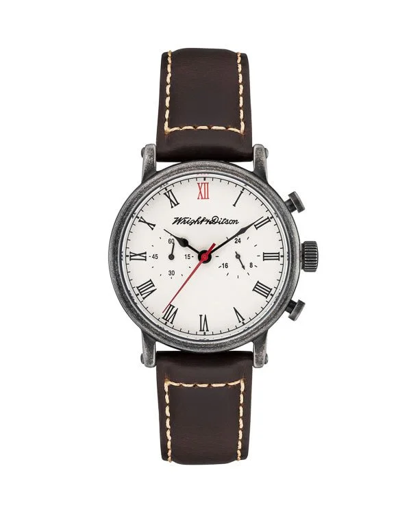 A wristwatch with a round white face, black Roman numerals, and a brown leather strap with white stitching.