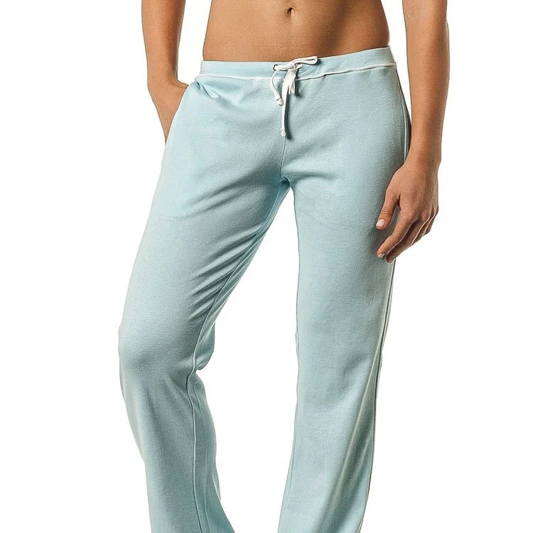 A woman wearing light blue sweatpants with a white drawstring, showing her torso and right hand hanging by her side.