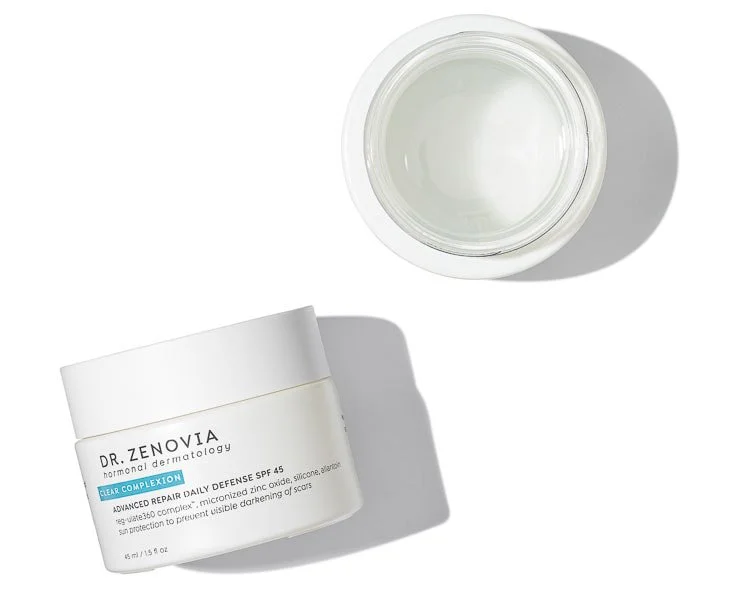 Open jar of skincare cream and a closed jar of skincare cream on a white background.