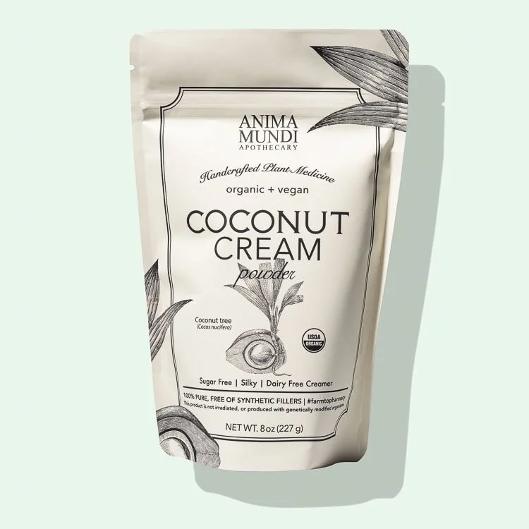 Packaging of Anima Mundi Apothecary coconut cream powder, labeled as handcrafted, organic, vegan, sugar-free, silky, dairy-free, and USDA organic, with illustrations of a coconut and palm leaves.