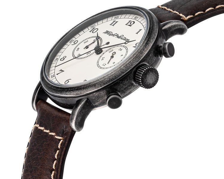 Vintage-style wristwatch with a black textured case, white dial, and leather strap
