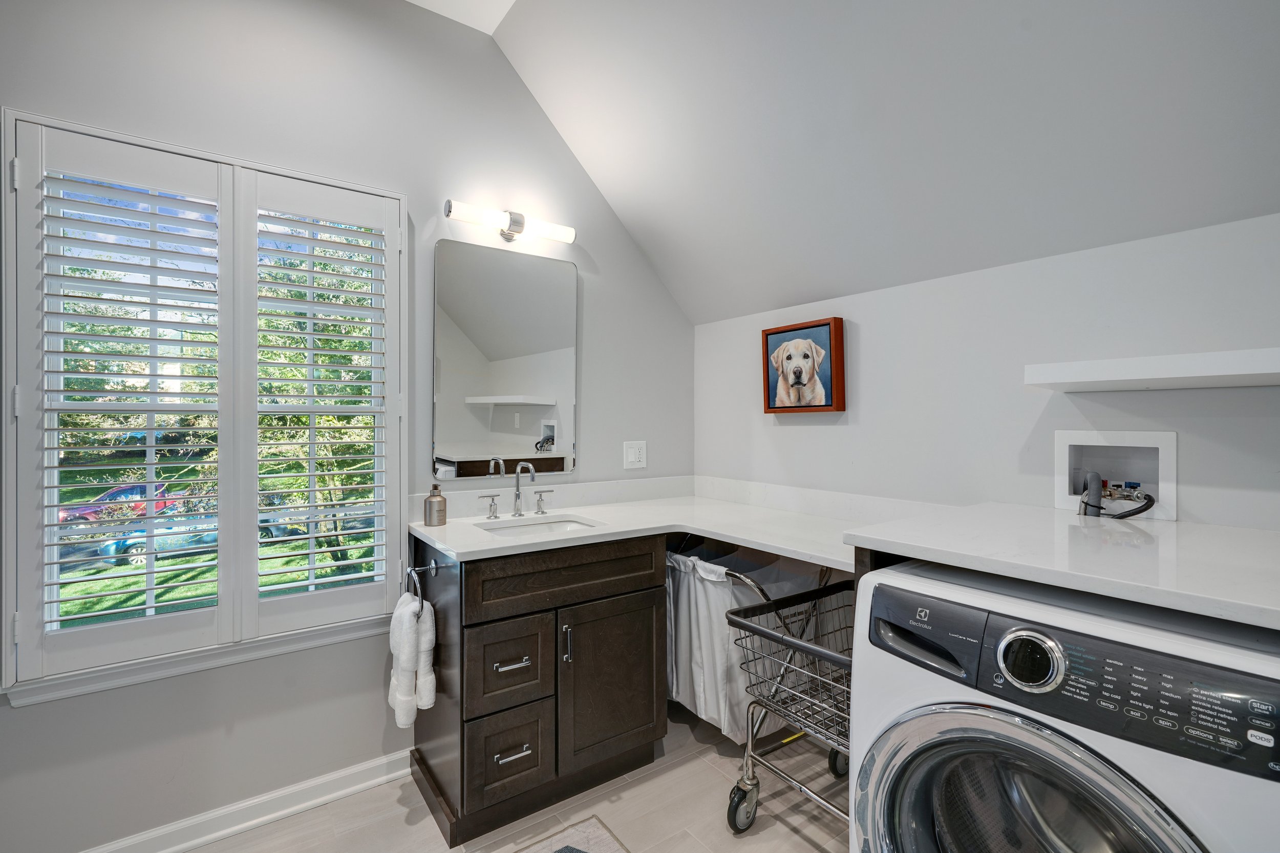 Primary bathroom, double under mount sink, glass shower, soaking tub, mudroom, laundry room, charcoal floor tiles, galley bathroom, light and airy.