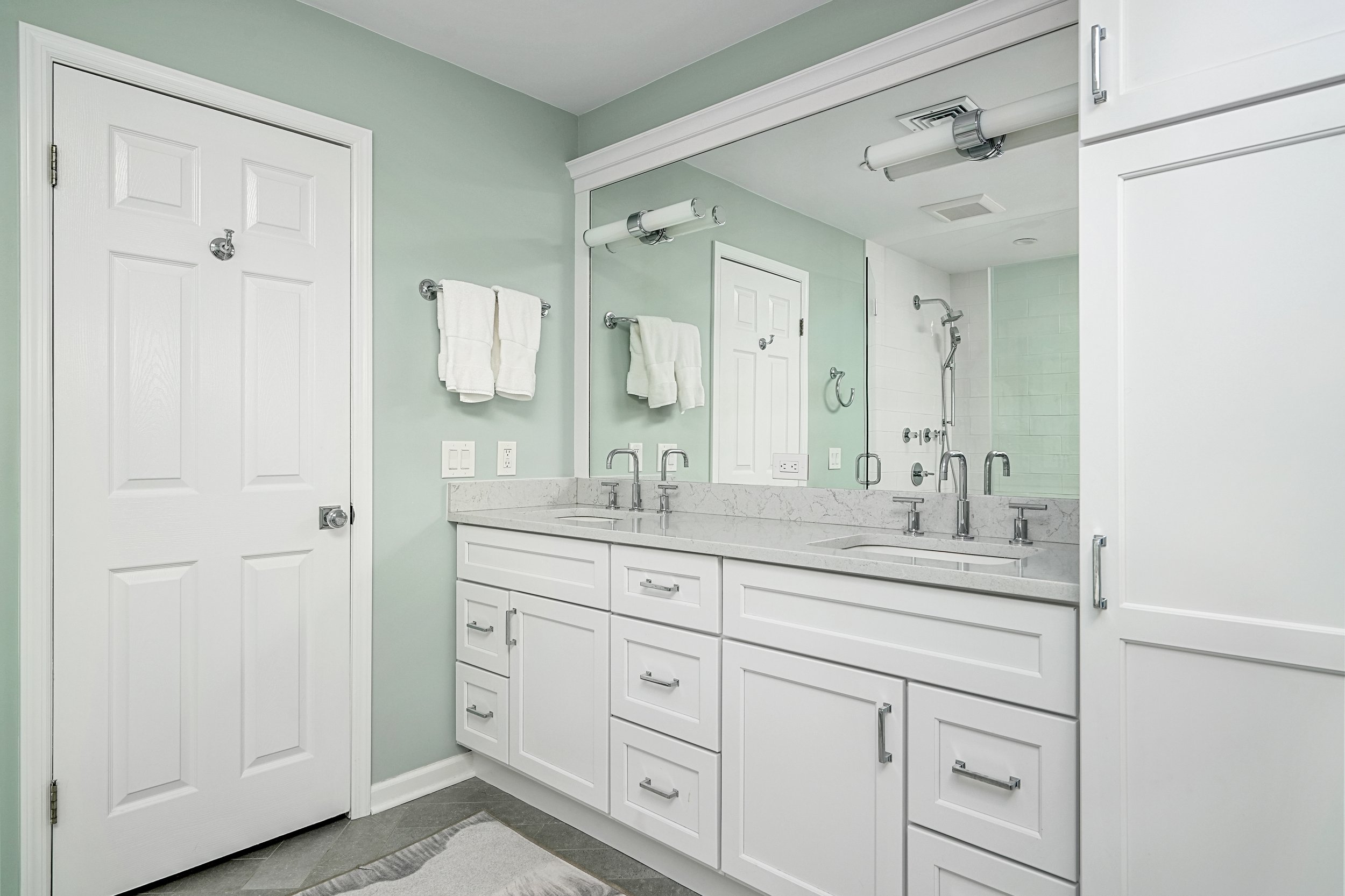 Primary bathroom, double under mount sink, glass shower, soaking tub, mudroom, laundry room, charcoal floor tiles, galley bathroom, light and airy.