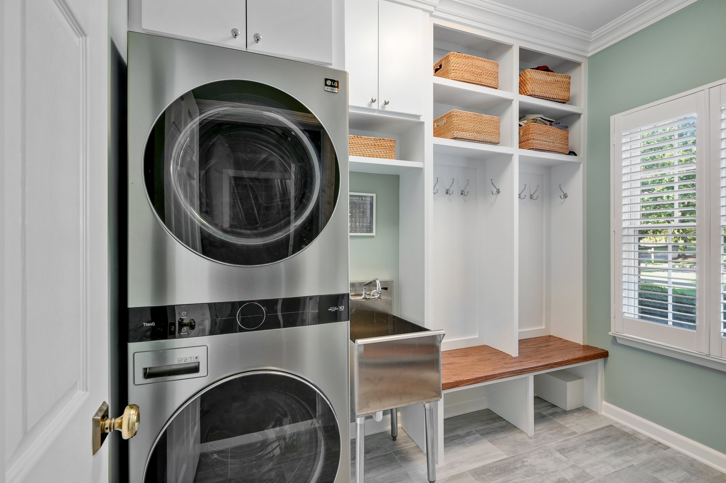 Primary bathroom, double under mount sink, glass shower, soaking tub, mudroom, laundry room, charcoal floor tiles, galley bathroom, light and airy.