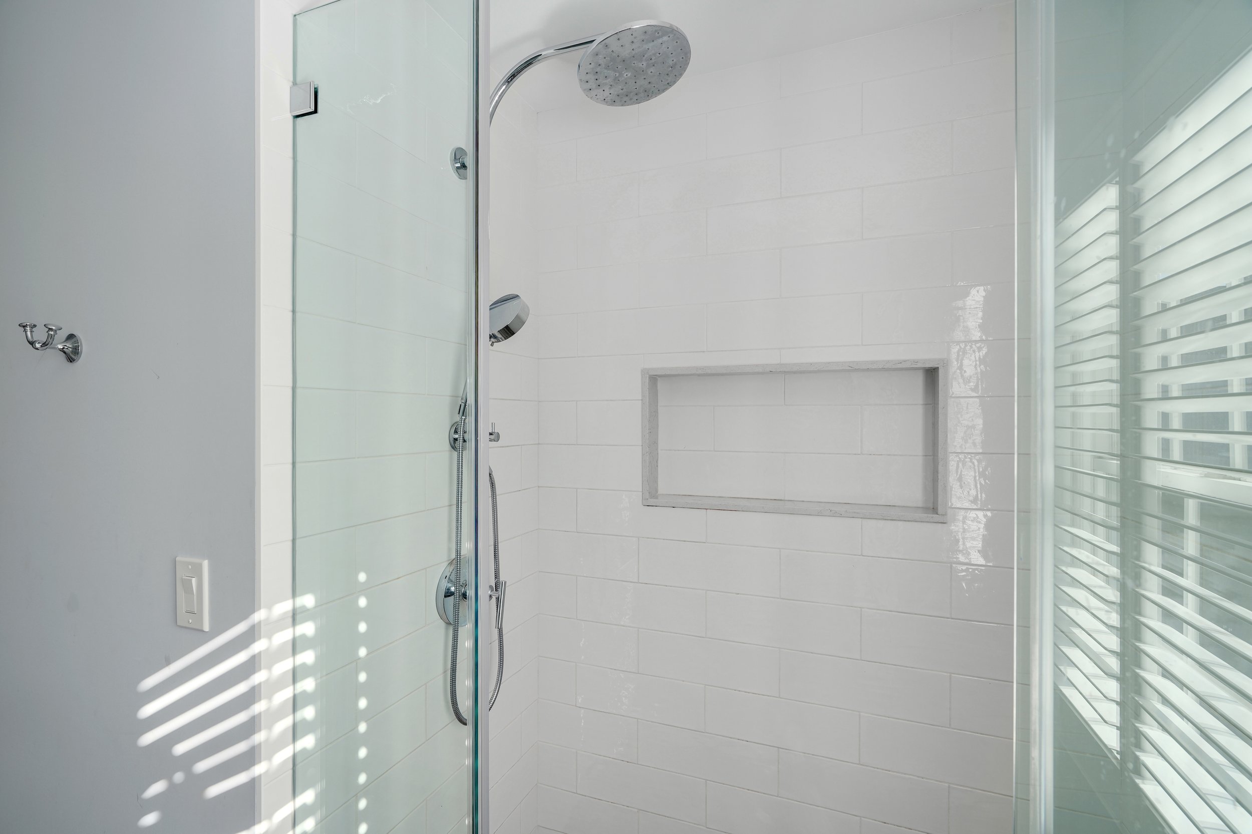 Primary bathroom, double under mount sink, glass shower, soaking tub, mudroom, laundry room, charcoal floor tiles, galley bathroom, light and airy.